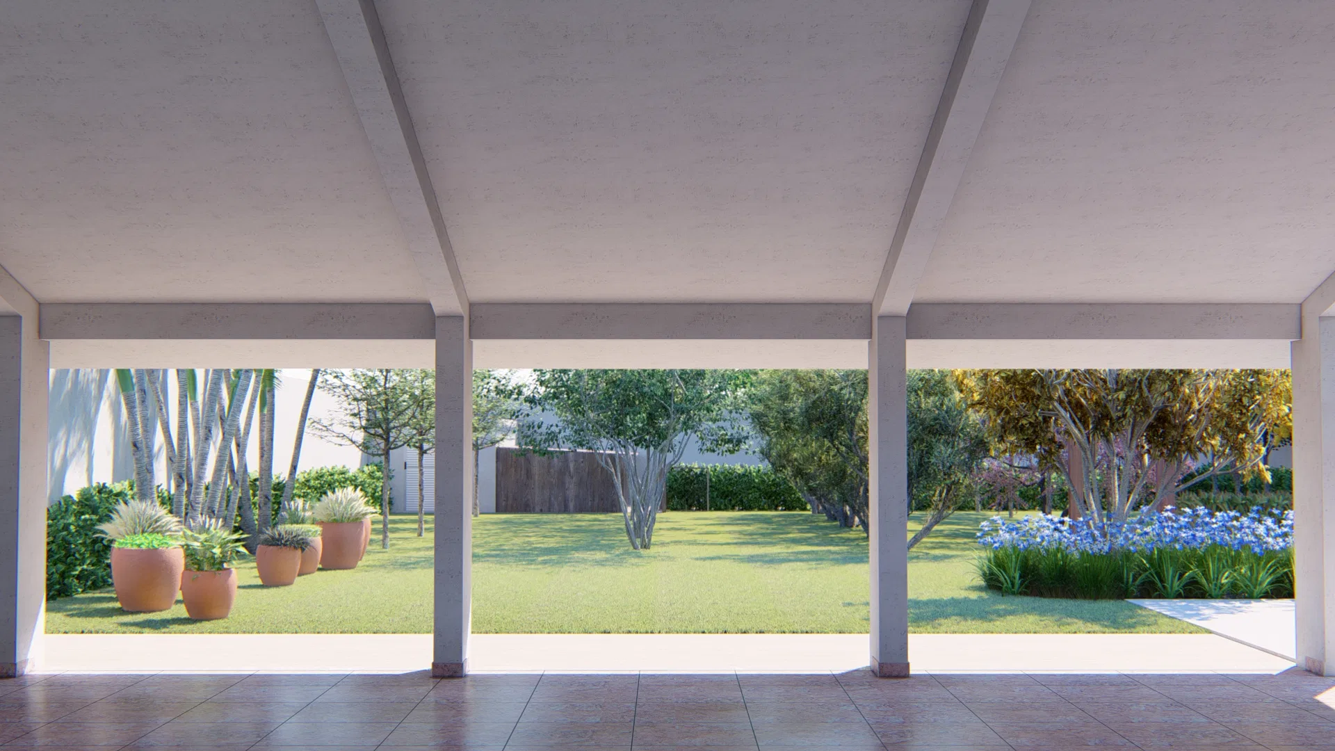 View of the garden from a covered veranda with pillars and a tiled floor, framing terracotta pots, lawn and a bed of blue flowers