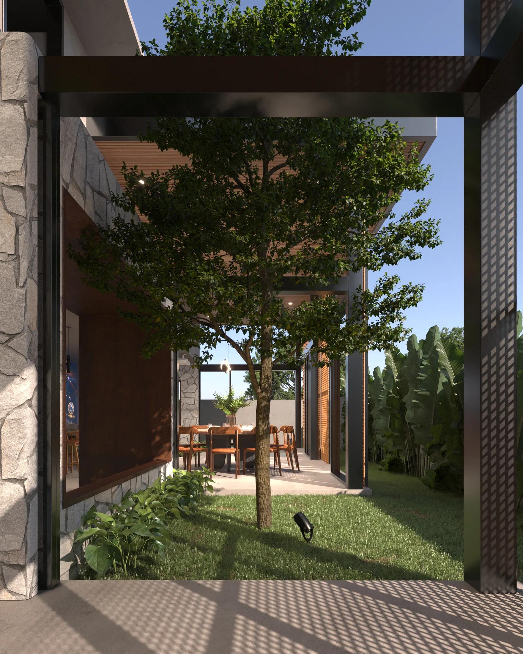 Internal courtyard with a tree beneath a pergola, a view into the dining room through the glass and tropical planting around it