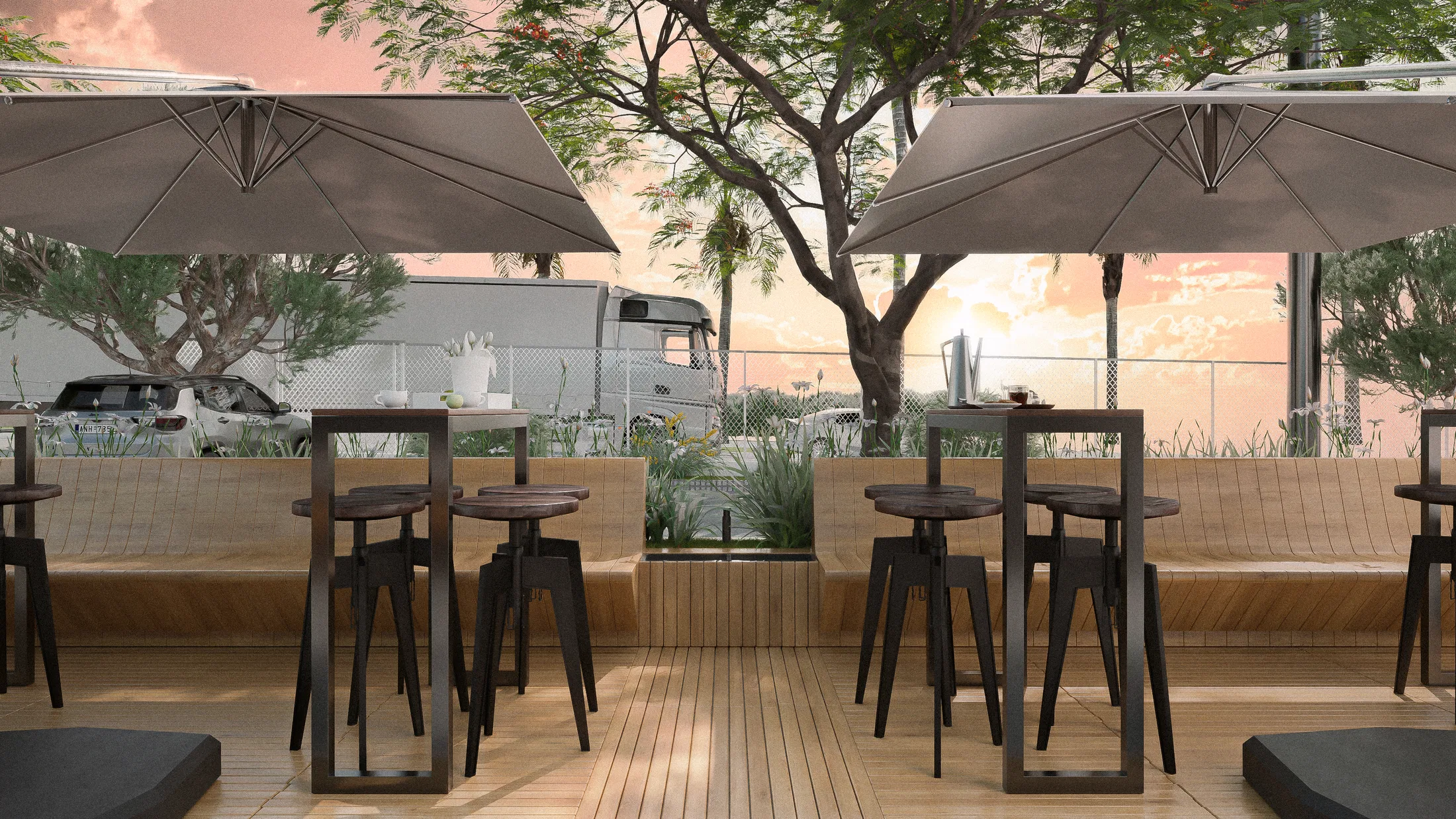 Wooden parklet at sunset with high tables, stools and parasols, beds of grasses and a tree, under an orange sky