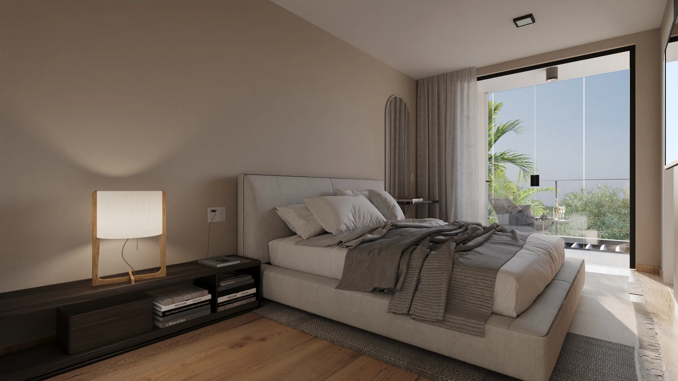 Master suite with a beige upholstered headboard, a table lamp and a wide balcony with palm trees and outdoor area beyond
