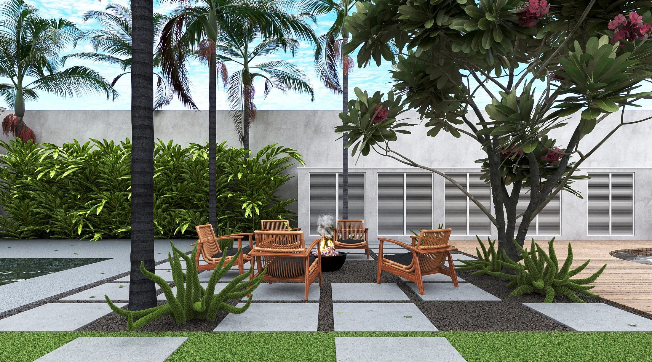 Outdoor lounge with wooden armchairs around a fire bowl, palms, a flowering frangipani and concrete pavers between grass and gravel