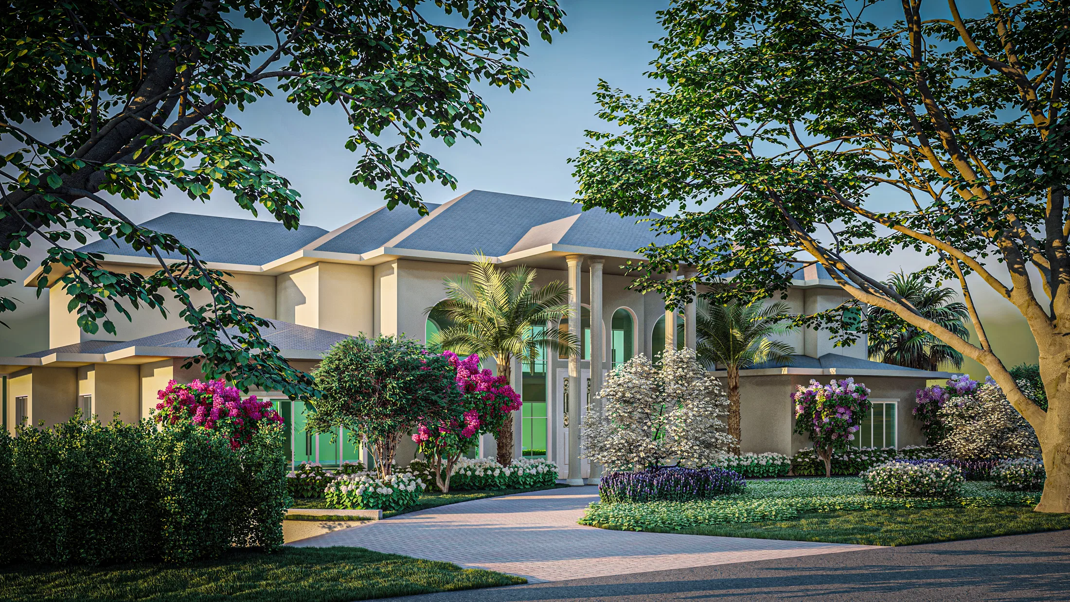 Pale classical façade with a slate roof, framed by trees and beds of bougainvillea, azaleas and white blooms along the driveway