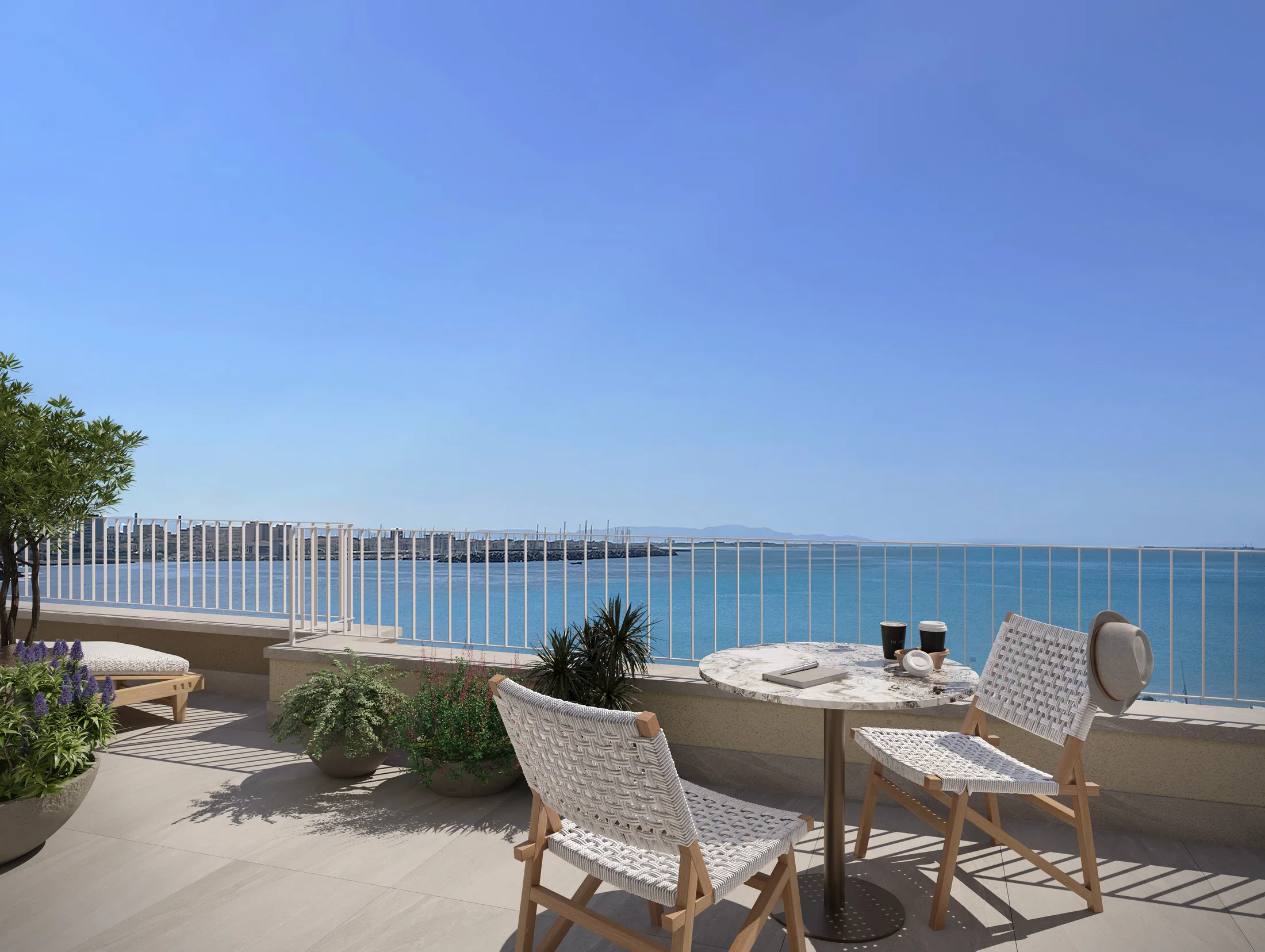 Rooftop terrace with a marble bistro table, woven chairs and planters overlooking the marina full of sailboats