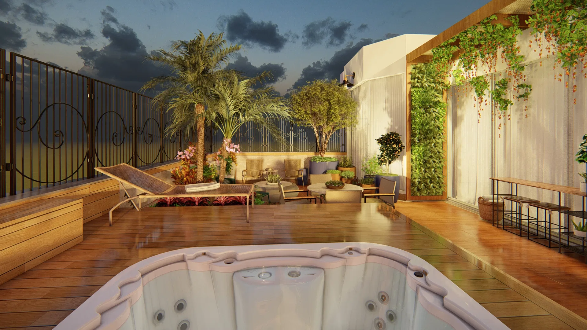 Dusk view with the spa in the foreground, lit palms, a lounger and a green wall under a cloudy sky