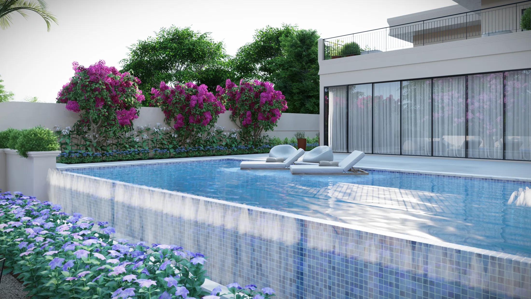 Elongated mosaic-tiled pool with submerged loungers, pink bougainvillea over the wall and blue hydrangeas in the foreground
