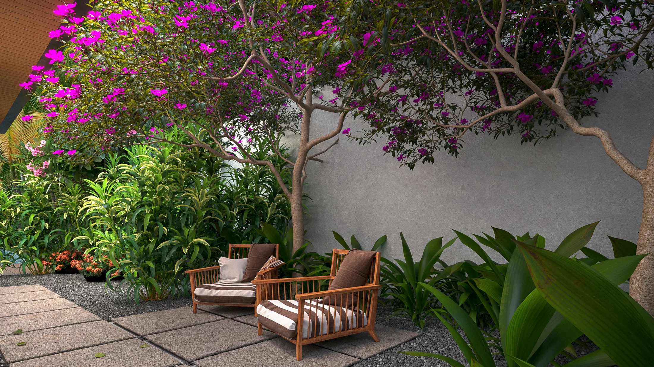 Seating corner with two wooden armchairs and striped cushions under a magenta bougainvillea, before a pale wall and a lush planting bed