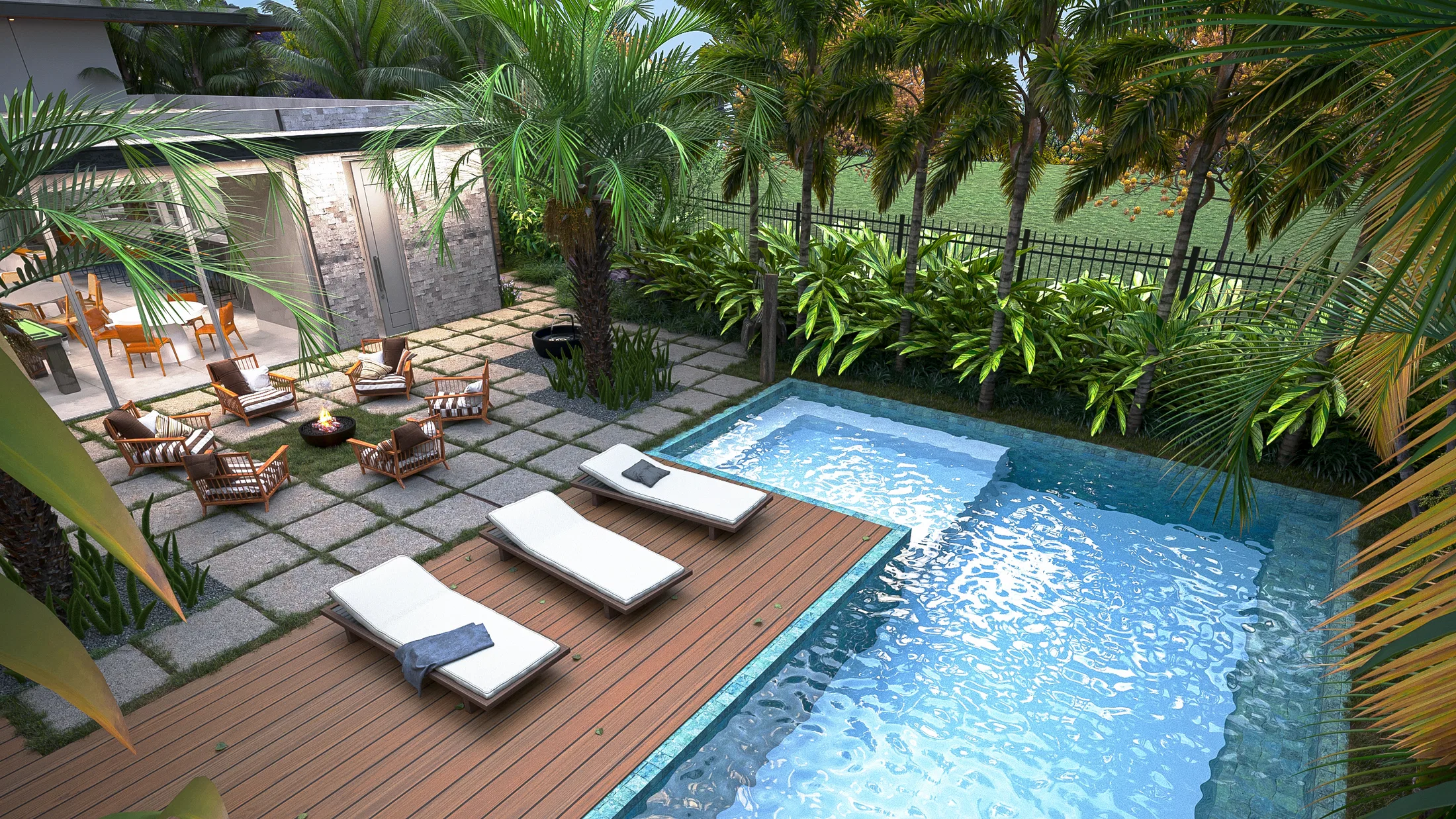 Elevated view of the L-shaped pool with a timber deck and sun loungers, a covered lounge area to the left and a dense hedge behind