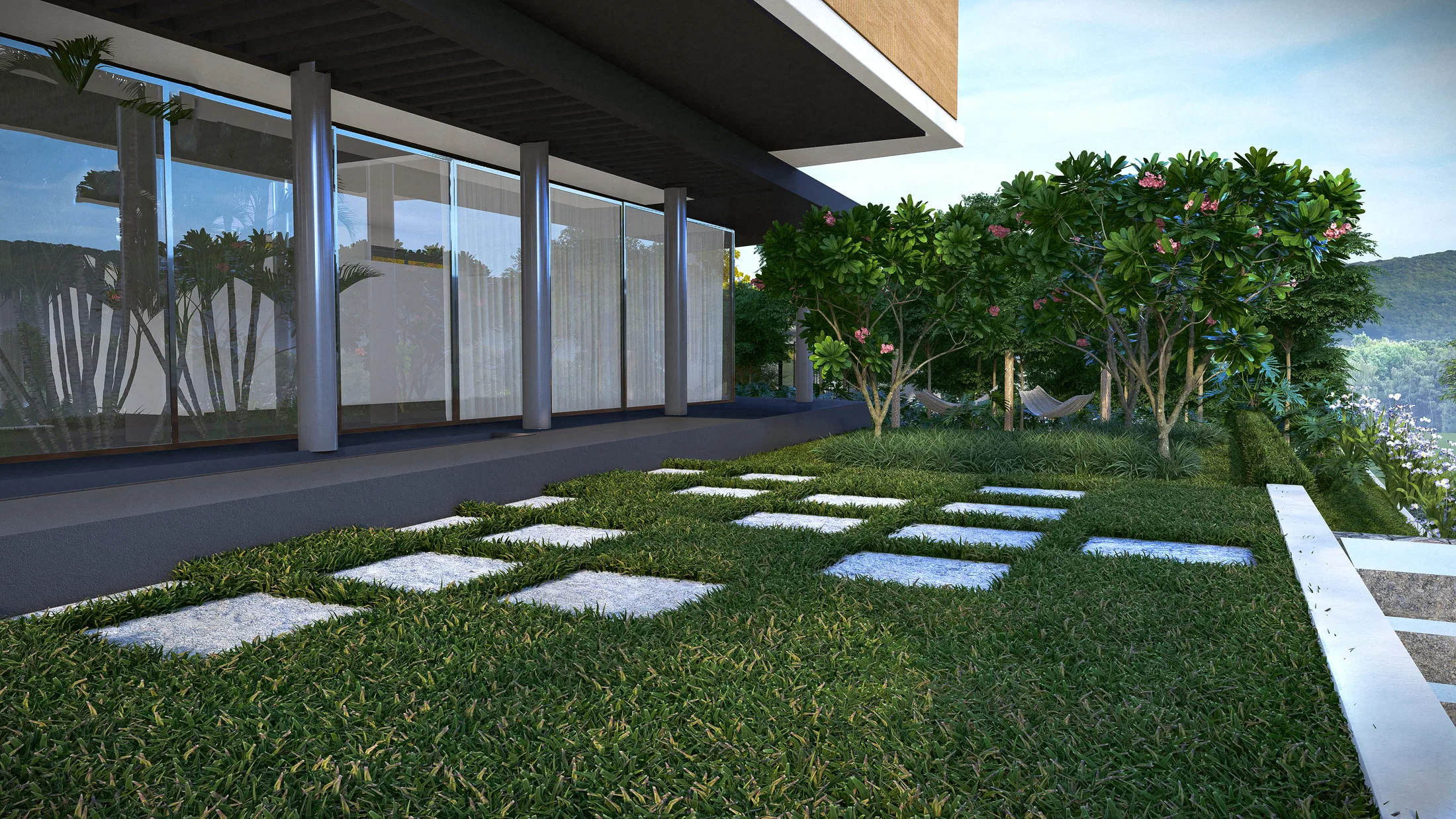 Glazed façade with slender columns and a path of concrete pavers across the lawn, flanked by flowering frangipani trees