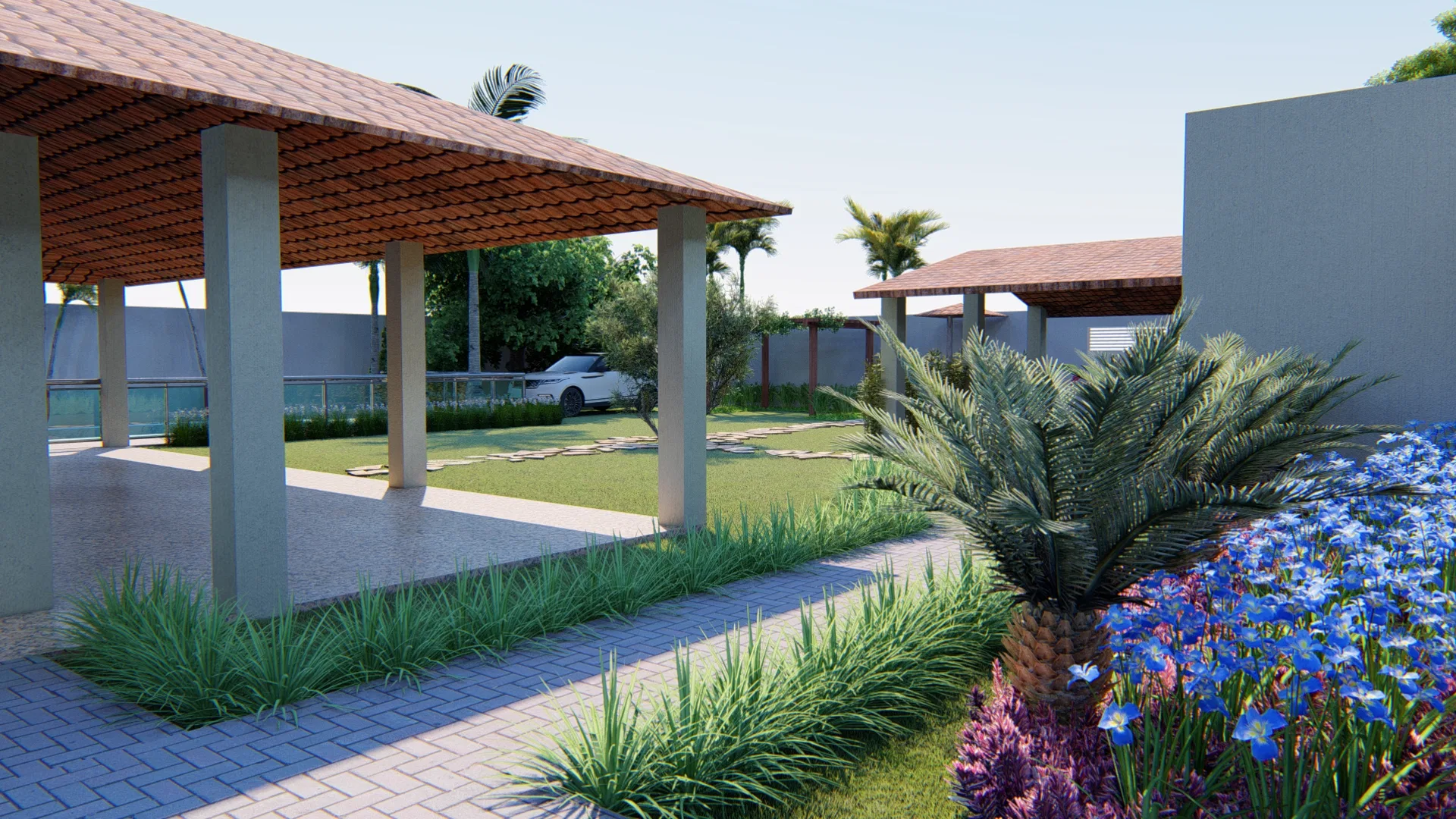 Carport covered by a pergola with a car parked, a vine bed and purple flowers framing the access