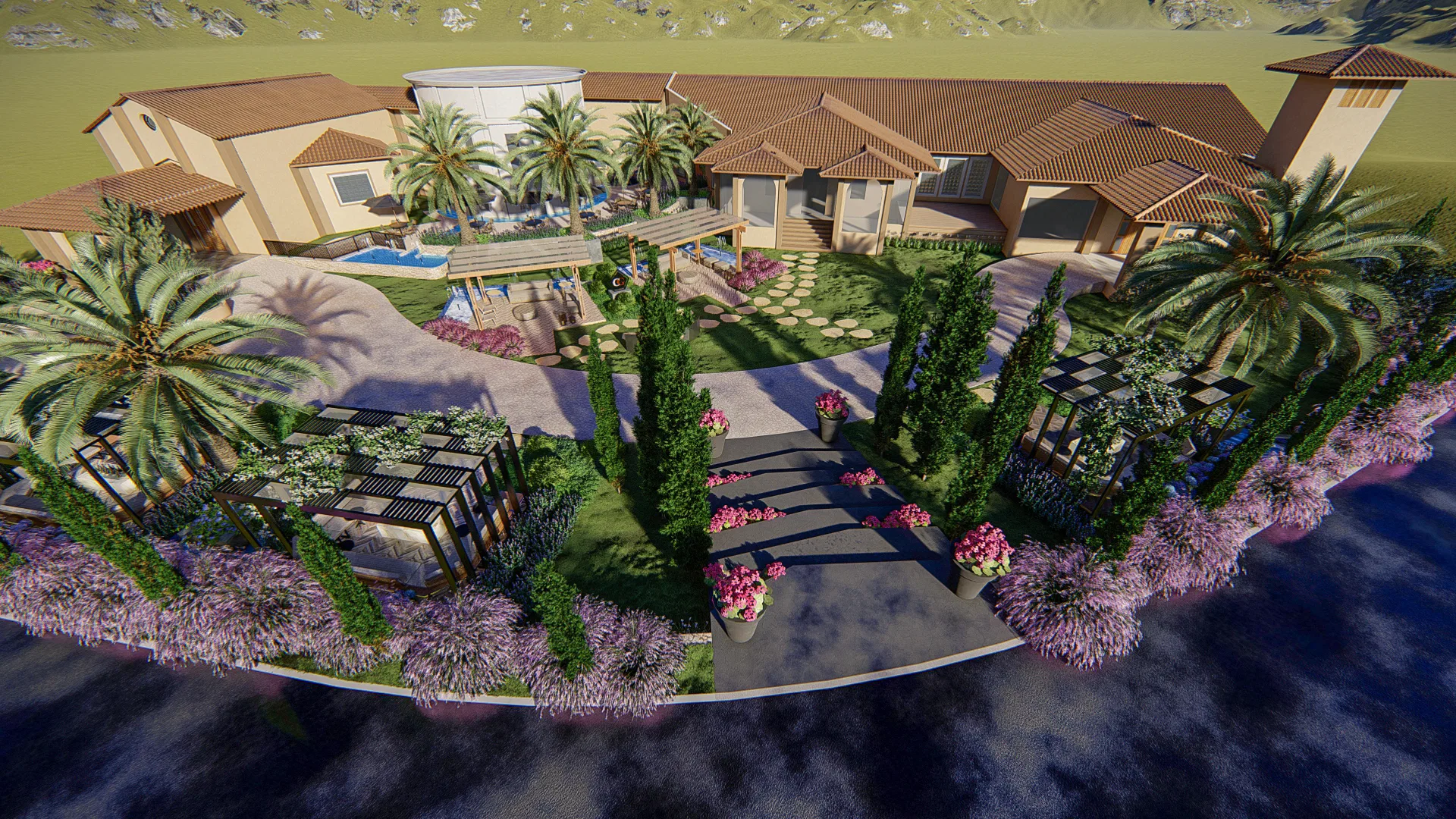 Wide aerial view of a property with clay-tile roofs, a pool, pergolas and rows of cypress trees among flowering beds