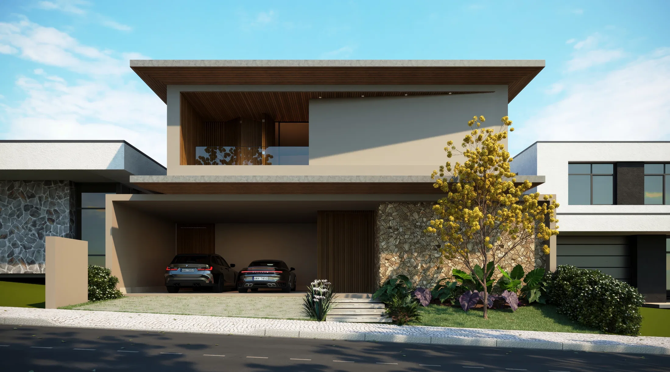 Front of a modern two-storey home with a covered carport for two cars, a stone-clad wall and a flowering yellow tree