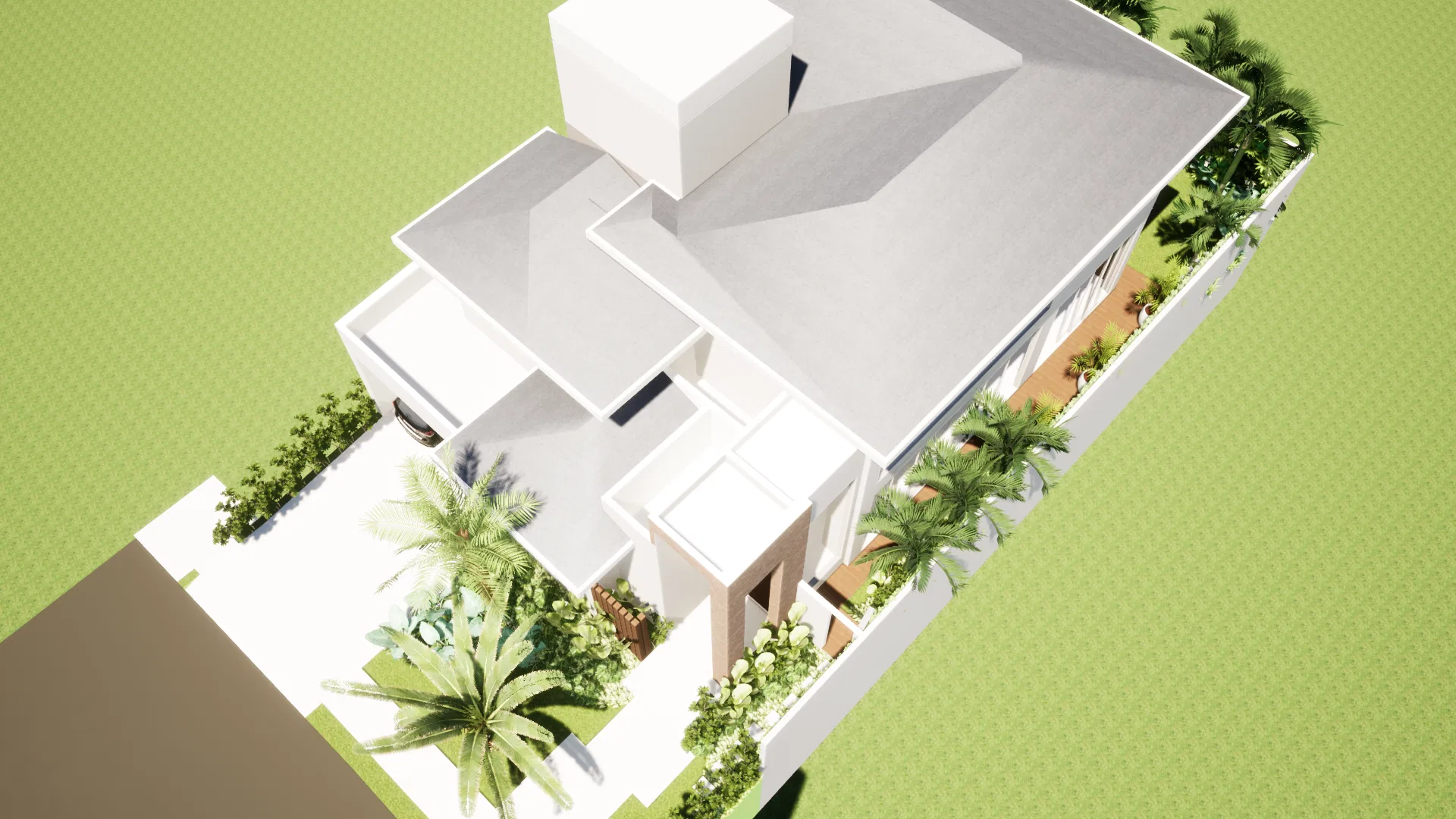 Top-down aerial with the house roof, landscaping tracing the plot boundaries, palms and beds arranged around the residence.