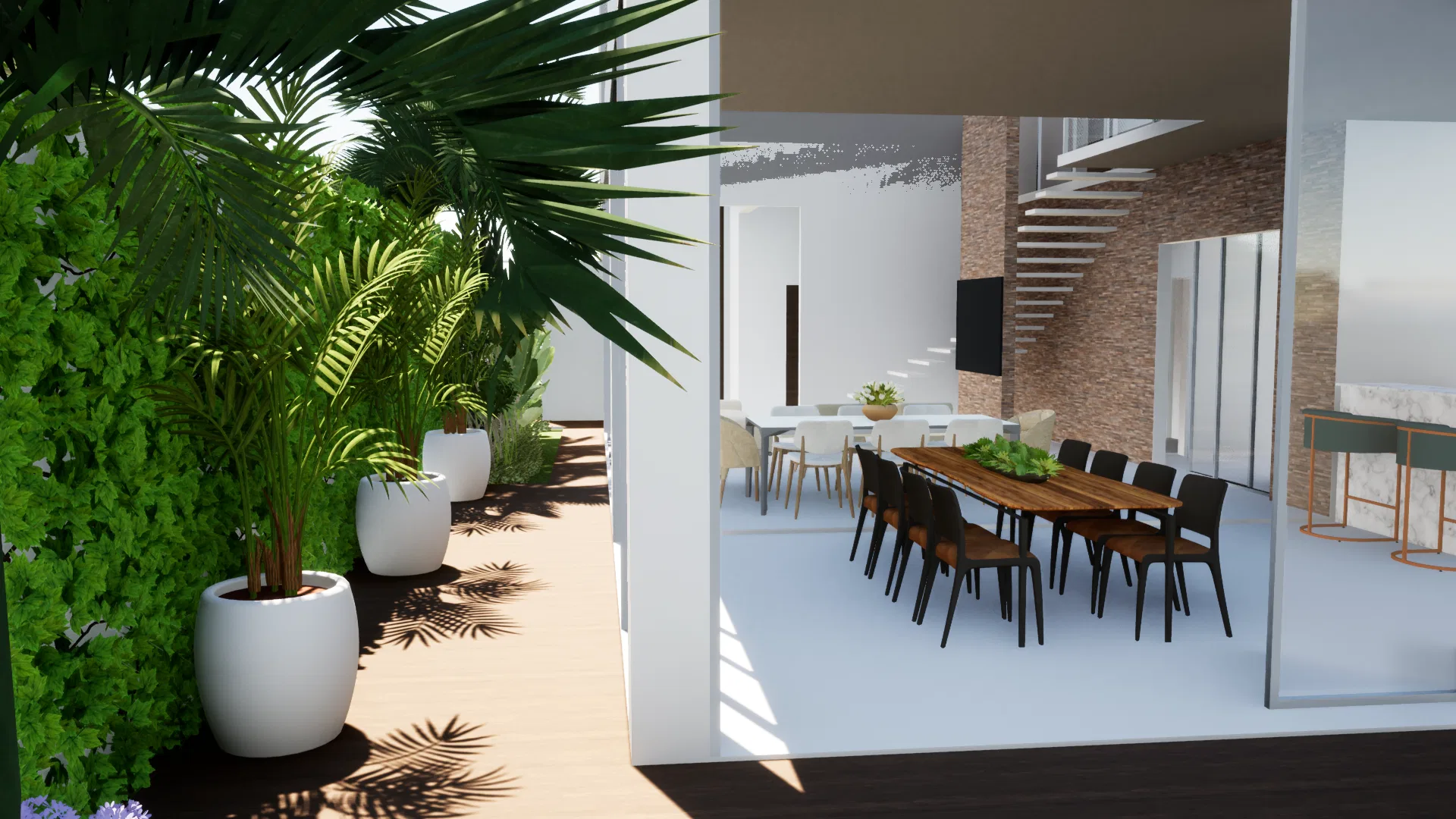 Covered terrace with palms in white pots on a timber deck, opening to the dining room with a long table, dark chairs and a staircase beyond.