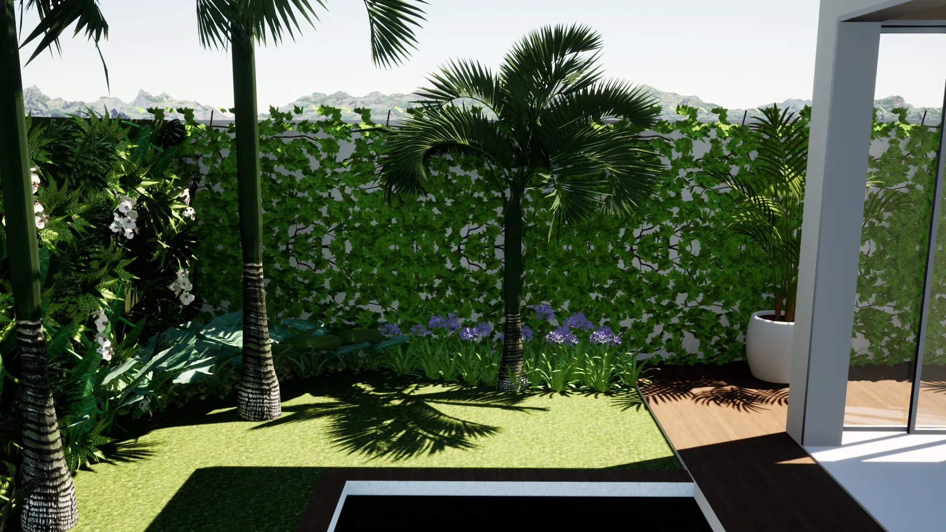 Rear nook with tall palms, a boundary wall clad in a vertical garden, masses of blue agapanthus and the dark edge of the pool by the deck.