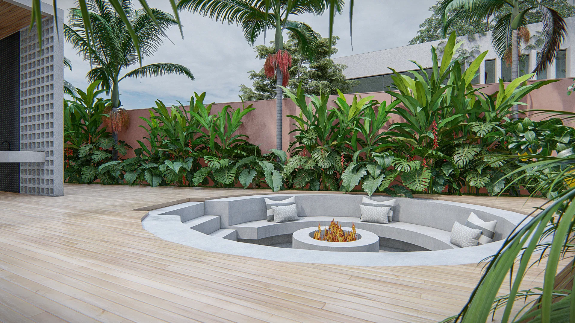 Circular sunken fire pit in the deck, with concrete seating and cushions, surrounded by tropical foliage
