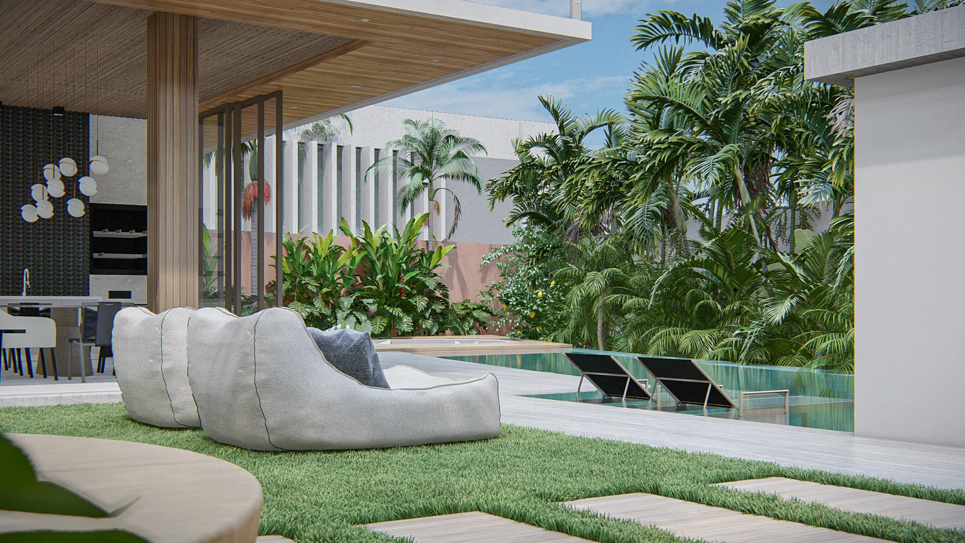 Covered lounge area beside the pool with rounded white sofas, timber decking and dense tropical planting in the background