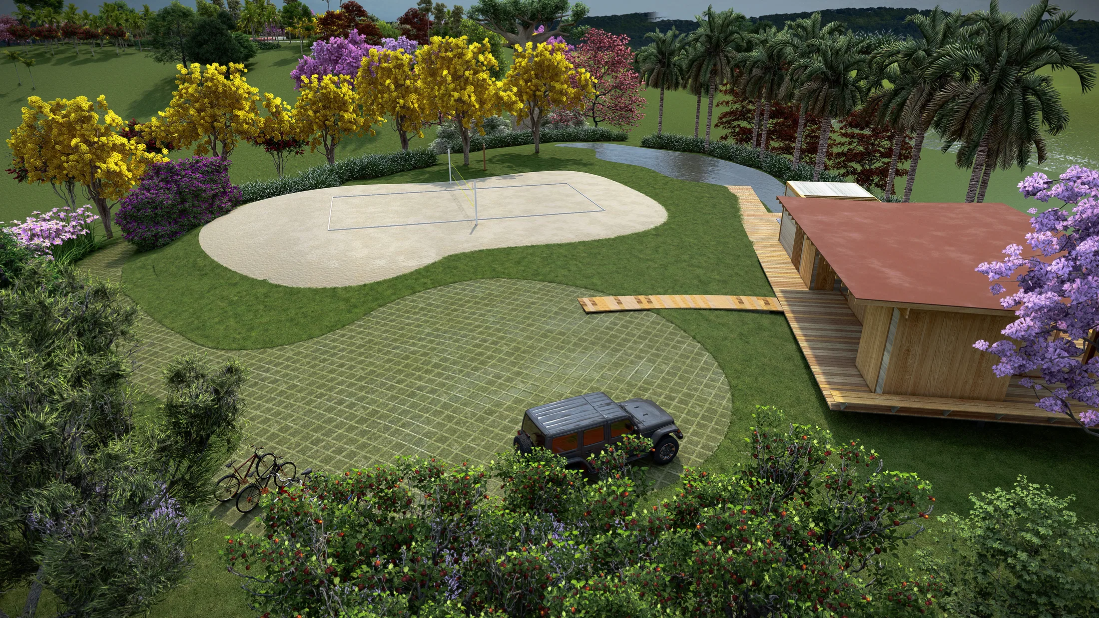 Aerial view of a sand volleyball court beside a small stream, with a wood-and-red-roof support house and a parked vehicle