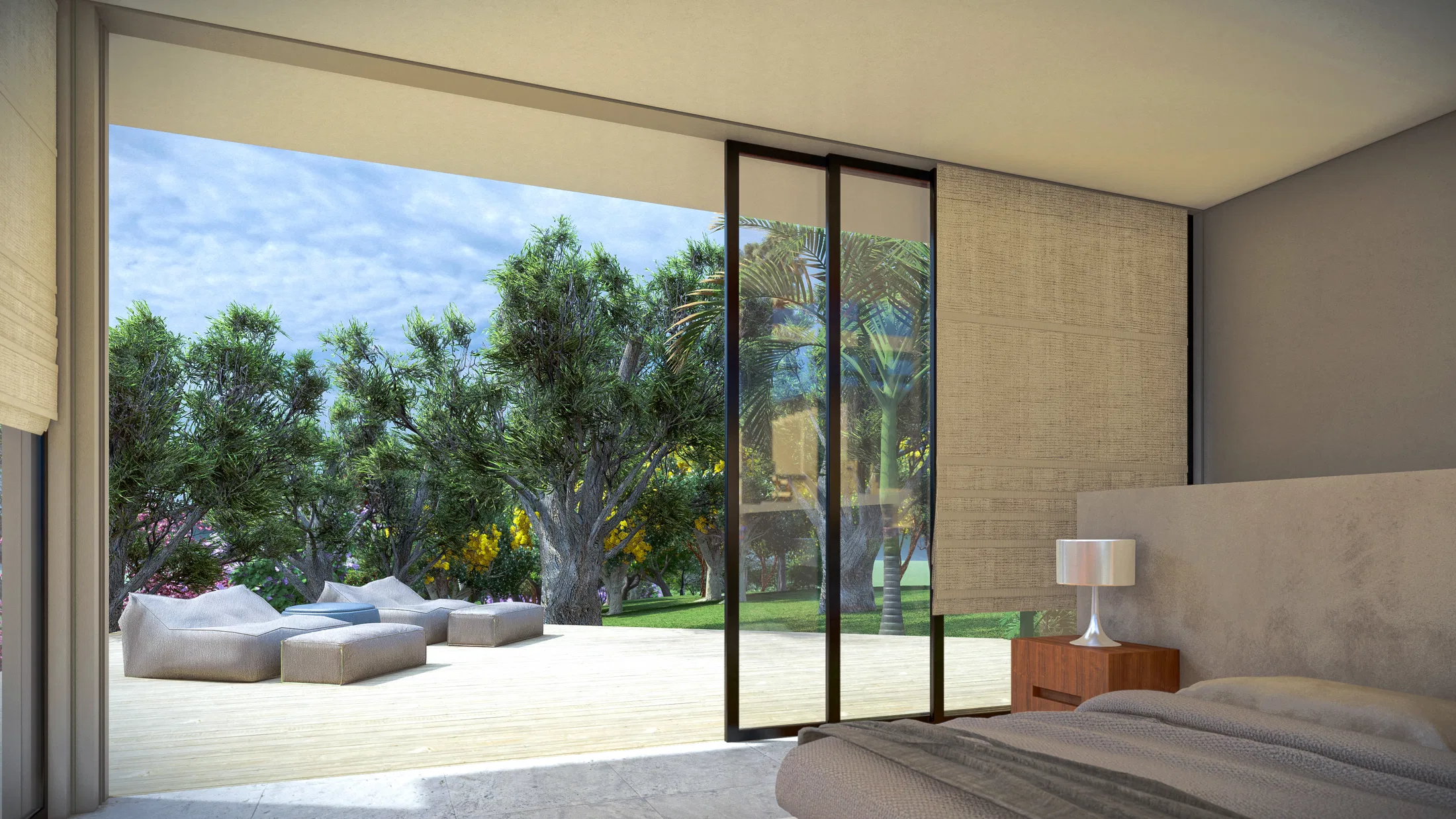 Bedroom with a sliding glass door open to a wood deck with lounge chairs among trees