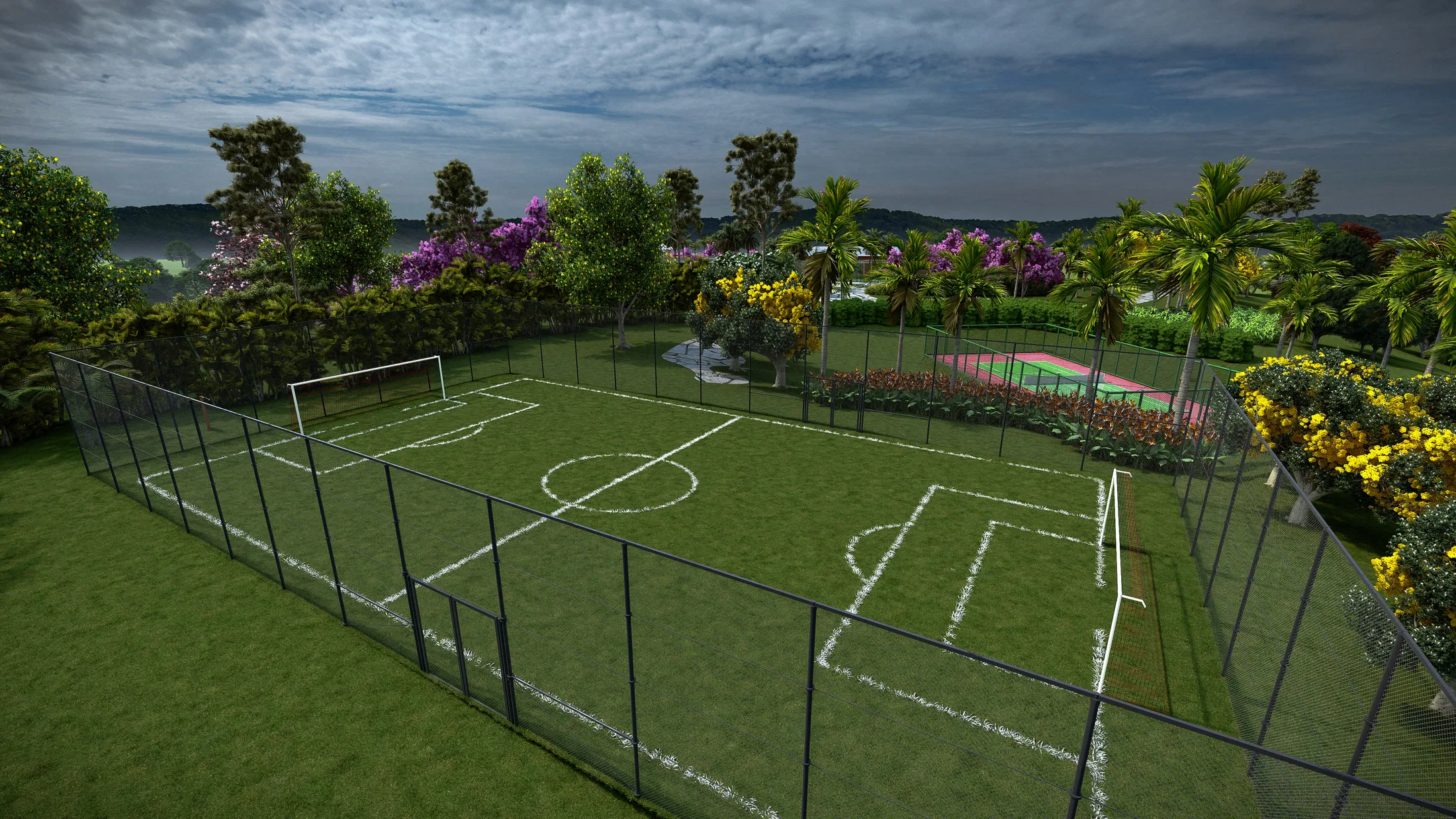 Fenced grass multi-sport court framed by yellow ipê trees and purple-flowering trees, with a tennis court in the background