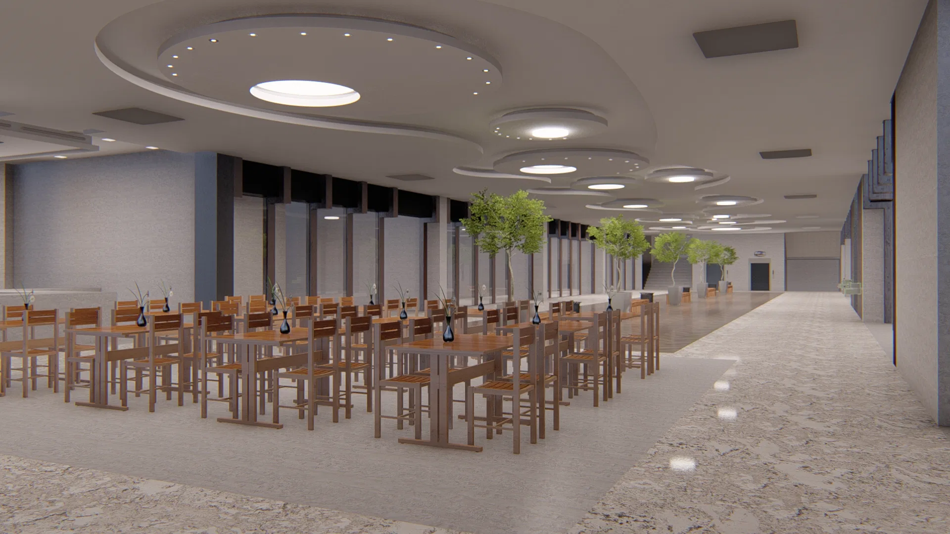 Large interior hall with wooden tables and chairs, a stepped circular ceiling with recessed lighting, potted trees and a terrazzo floor.