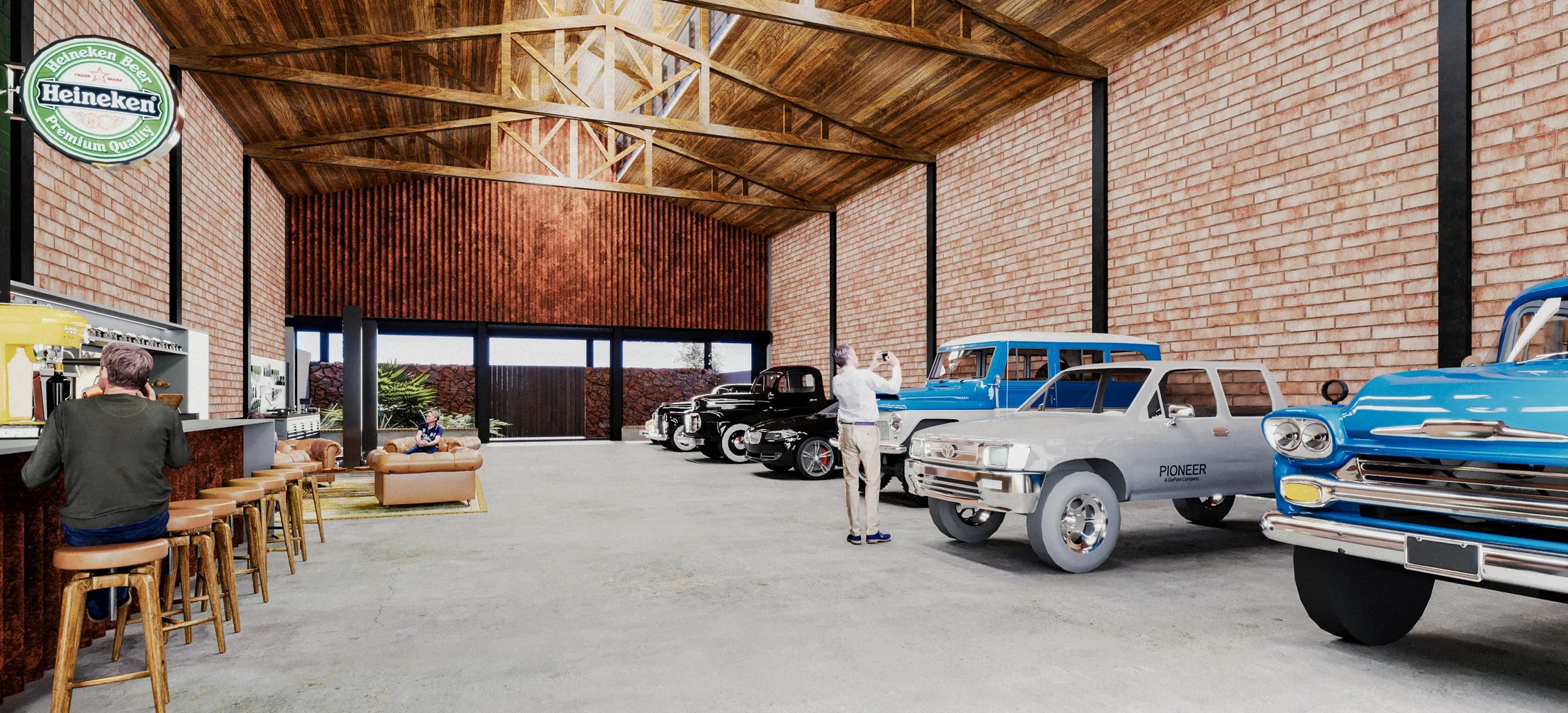 Wide view beneath the timber trusses, with exposed brick, a bar at the back and several classic pickups and cars on concrete flooring.