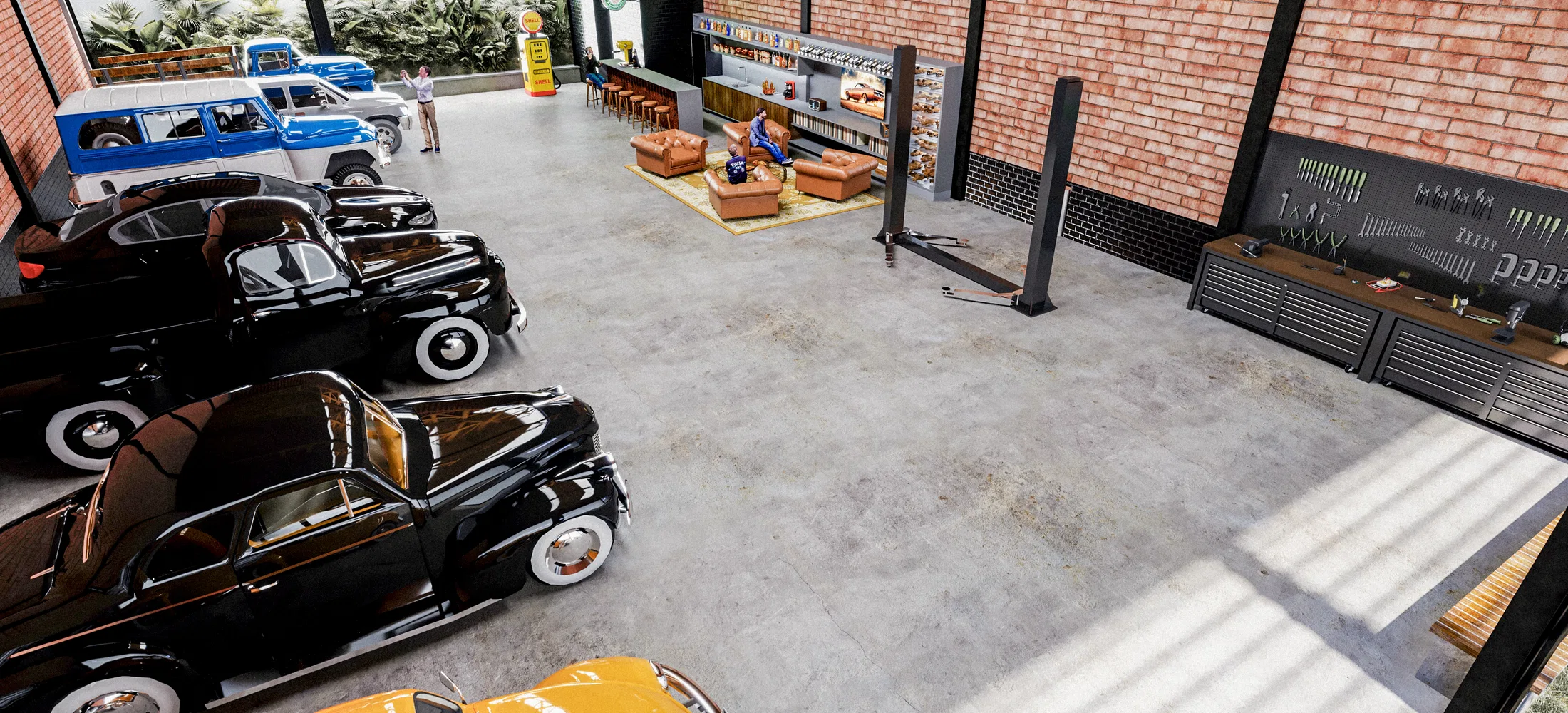Elevated interior view with a row of dark classic cars, a car lift, a leather-sofa lounge and a tool bench against the brick wall.