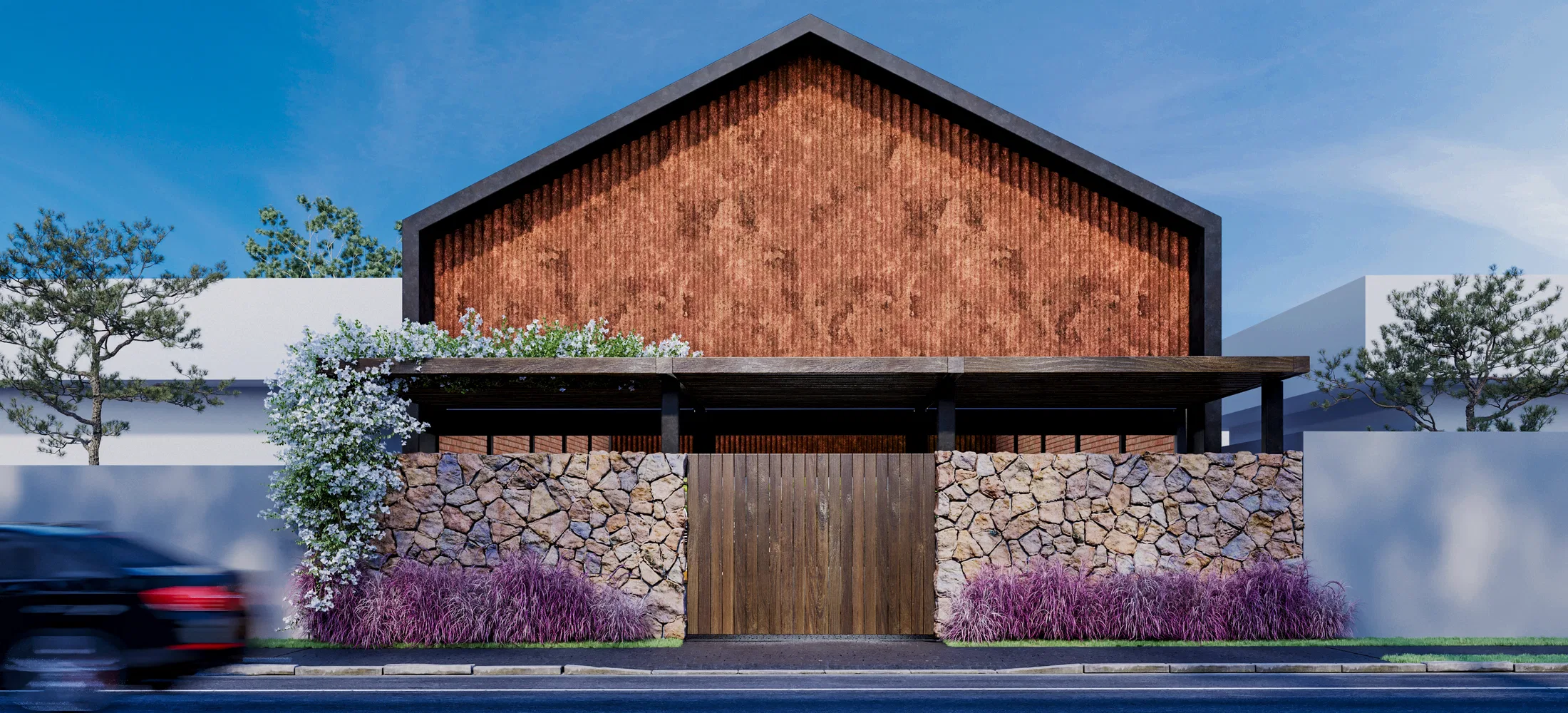 Gabled barn facade with a timber-batten upper wall over brick, a stone base, a wooden gate and purple ornamental grasses.