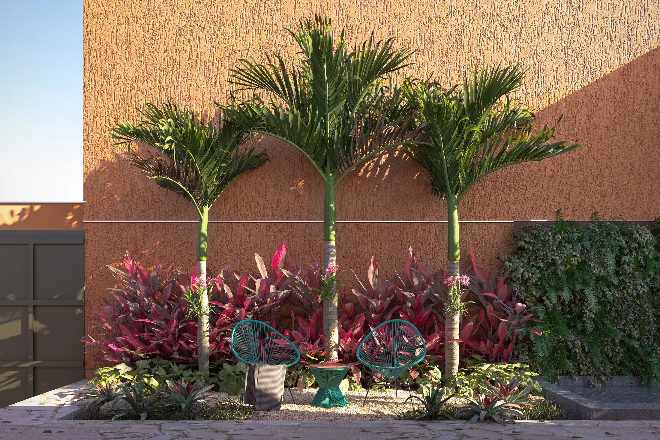 Lounge corner beneath three areca palms, with seafoam wicker chairs and a side table set among wine-red foliage planting