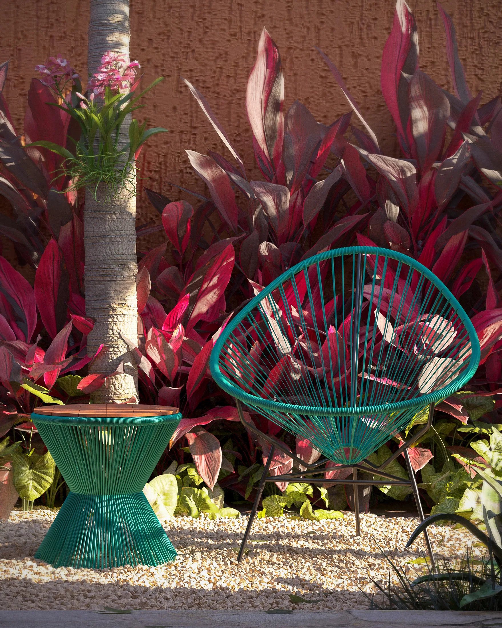Detail of a seafoam wicker chair and side table beside a palm trunk with an orchid, set among wine-red foliage