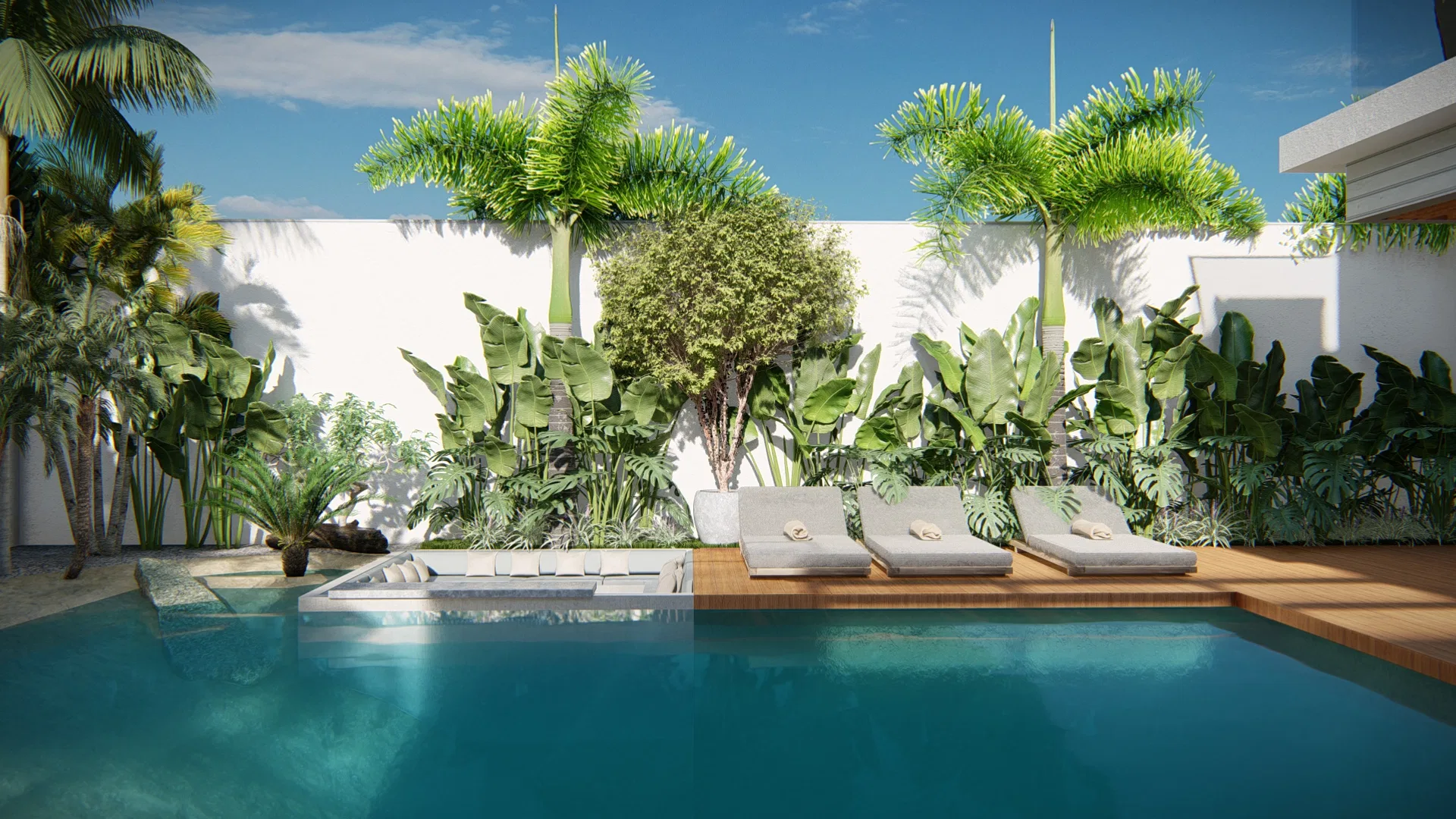 Wooden deck with three loungers at the pool edge and a tropical mass of palms, a clipped shrub and broad leaves behind