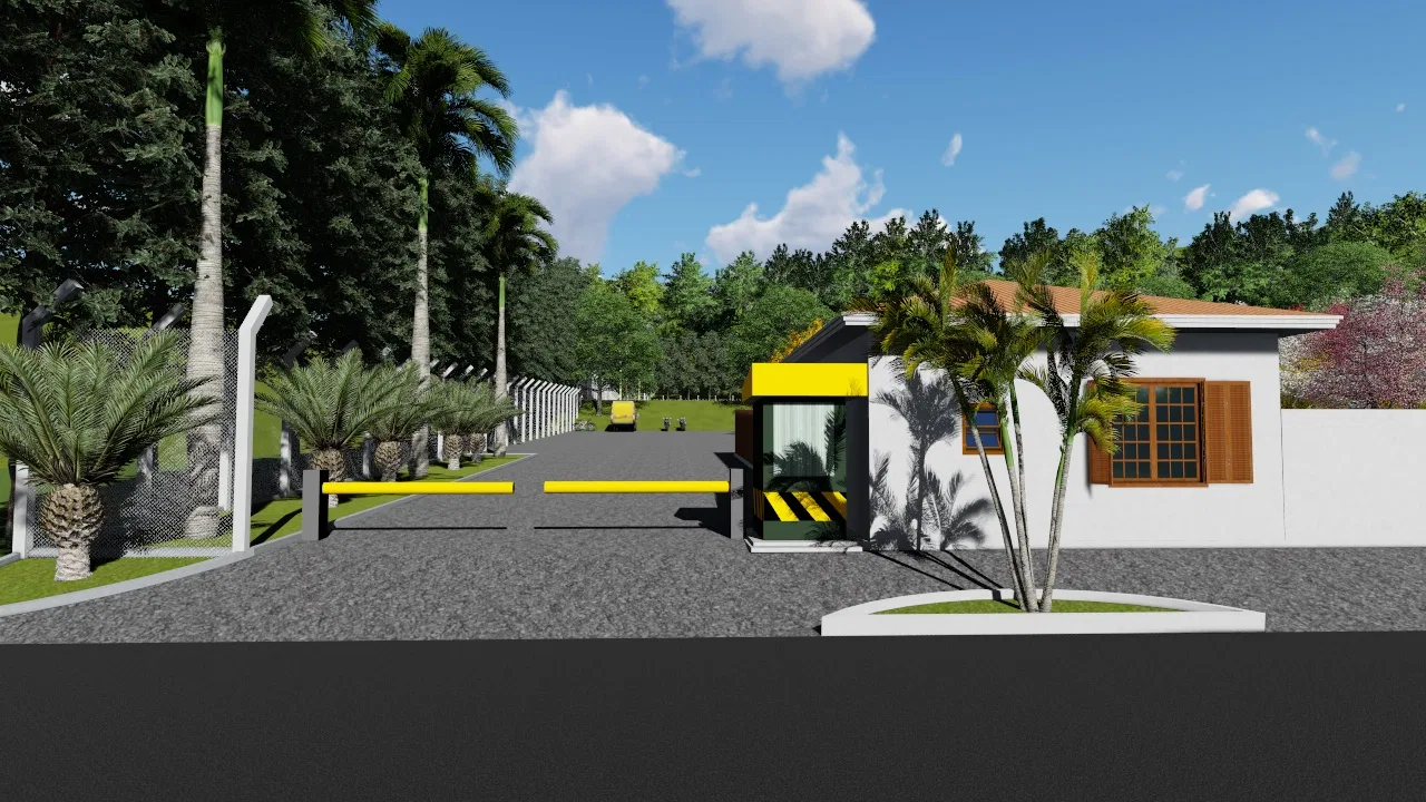 Community gatehouse with a yellow-accented booth and a striped boom barrier, an asphalt drive, palms along the railing and a low tile-roofed building