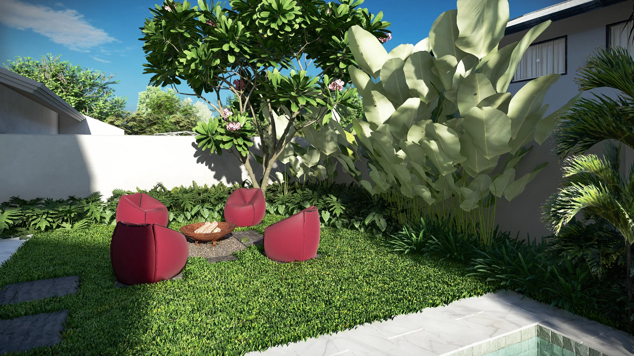 Closer view of the red armchairs around the fire pit beneath the canopy of a flowering tree