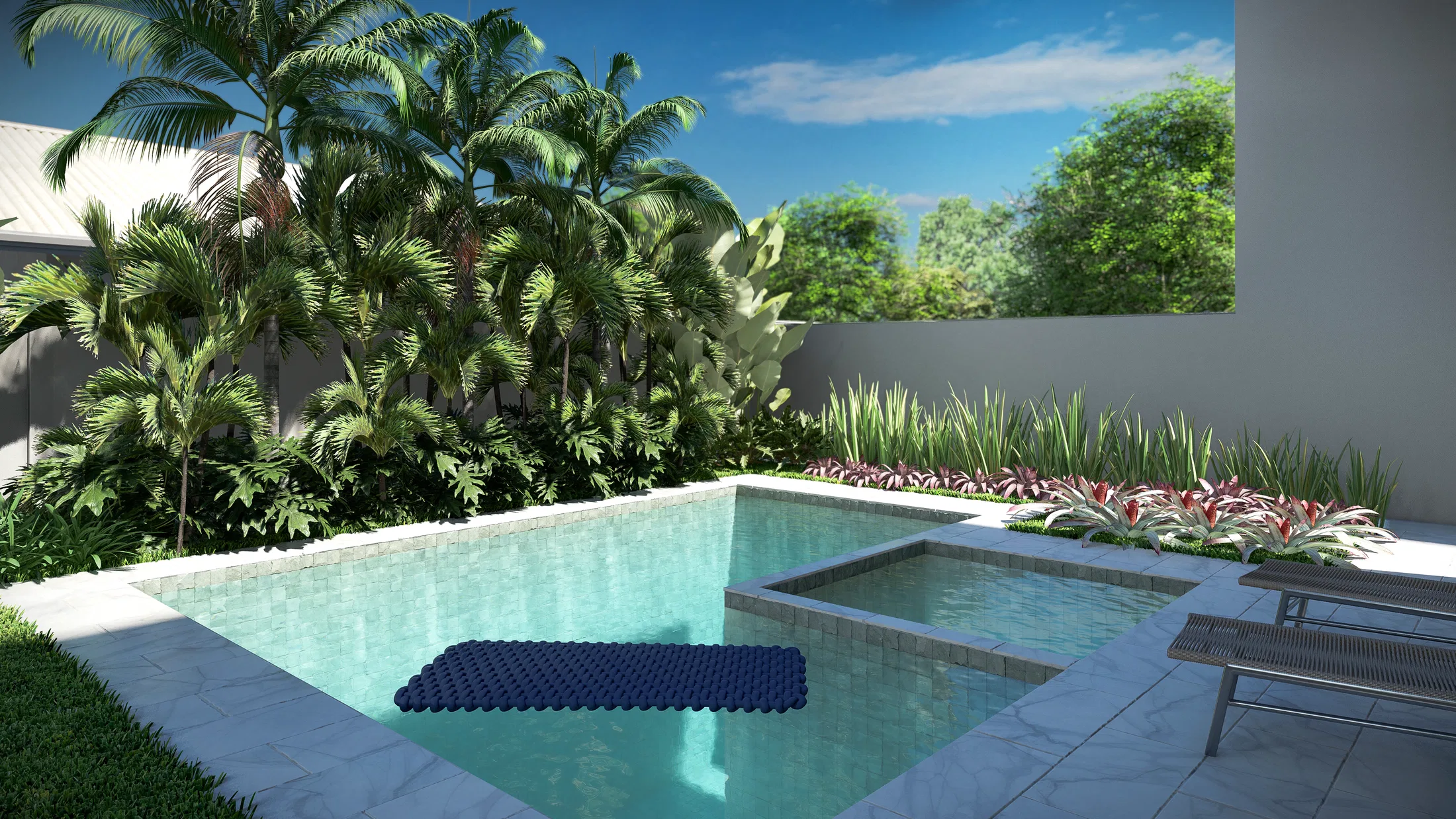 Pool with an integrated spa framed by palms and dense planting along the backyard wall