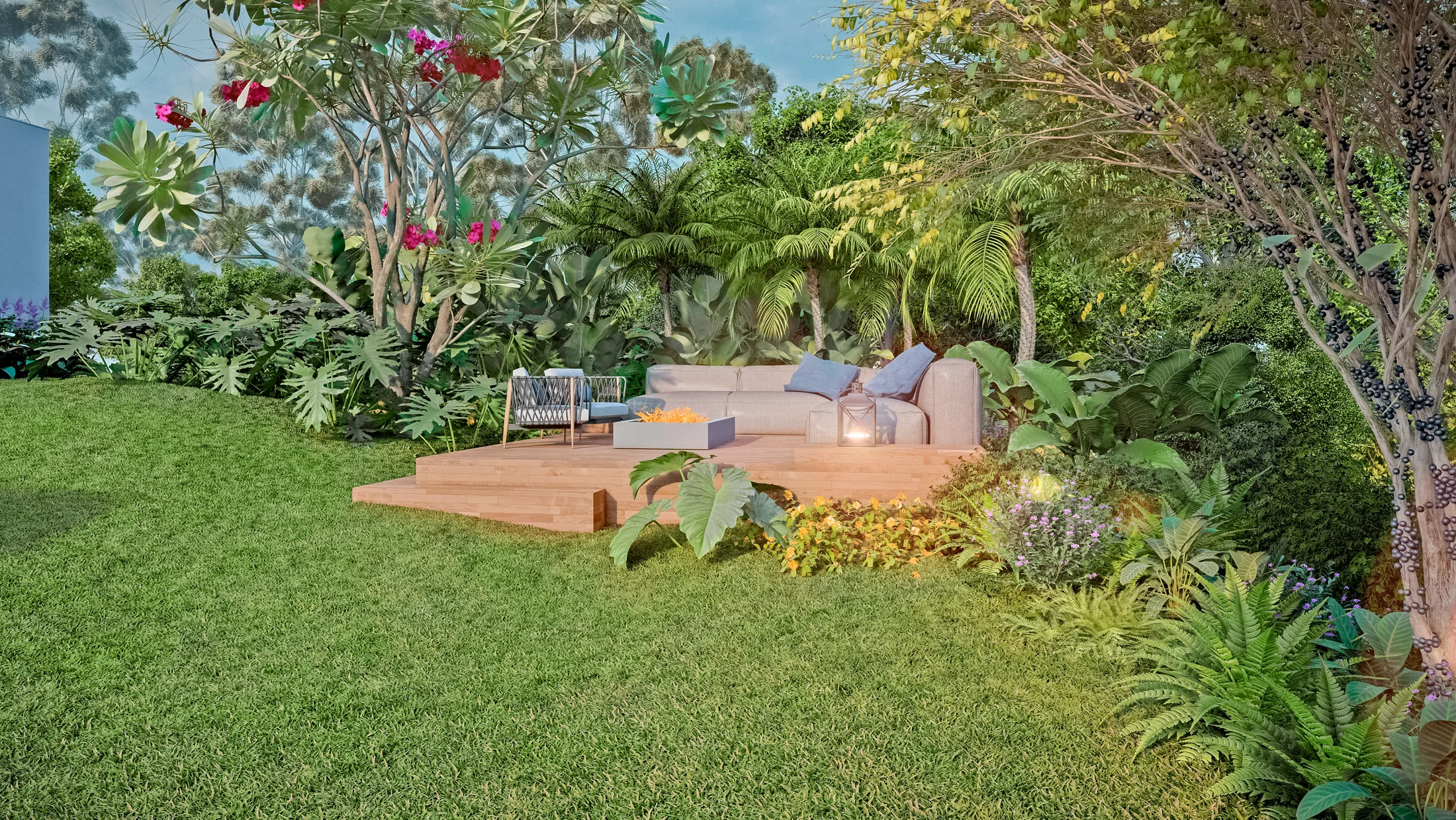 A timber deck on the lawn holding a pale sofa, armchair and lit fire-pit table, framed by palms and dense planting at dusk.
