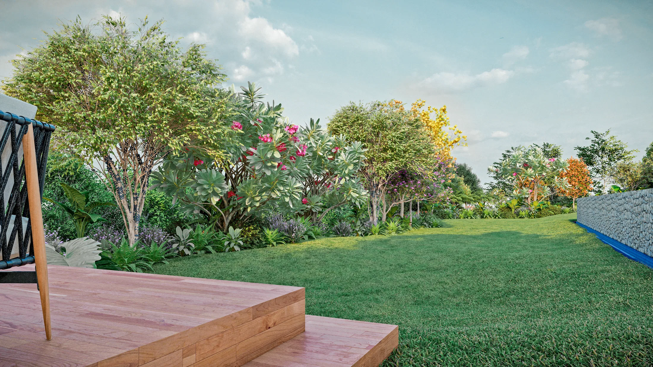Timber deck steps facing a broad lawn, with flowering shrubs, small trees and a gabion wall in the background on the right.