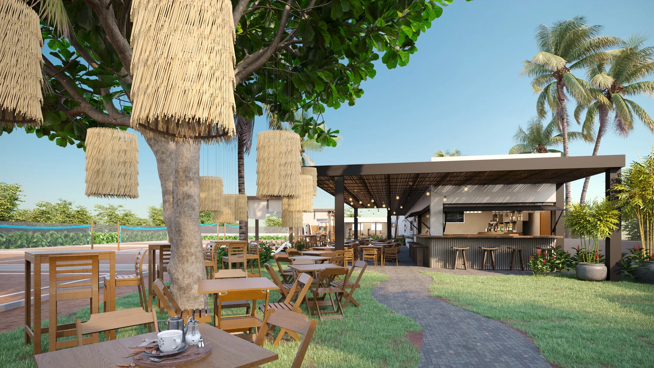 Dining area under a large tree with fiber pendant lamps, folding wood chairs on grass and a stone path leading to the covered bar among palm trees