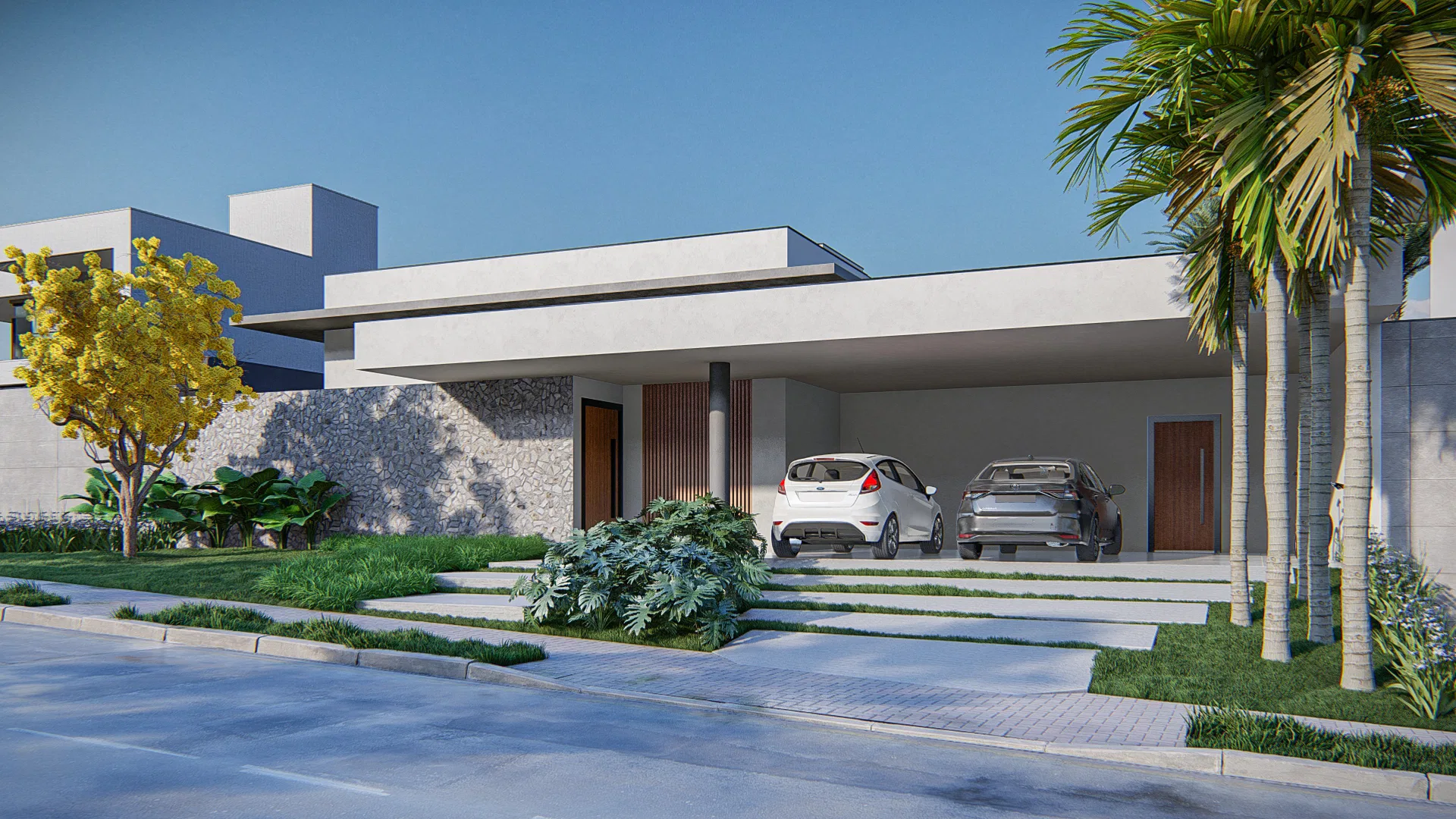 Single-storey house facade with a covered carport and two cars, a stone wall, a yellow-flowering ipê and palms over street-side beds.