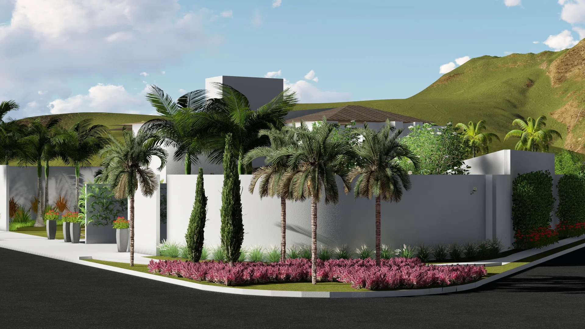 Corner of the residence with white walls, a cluster of palms and a cypress, a bed of pink flowering shrubs and mountains behind