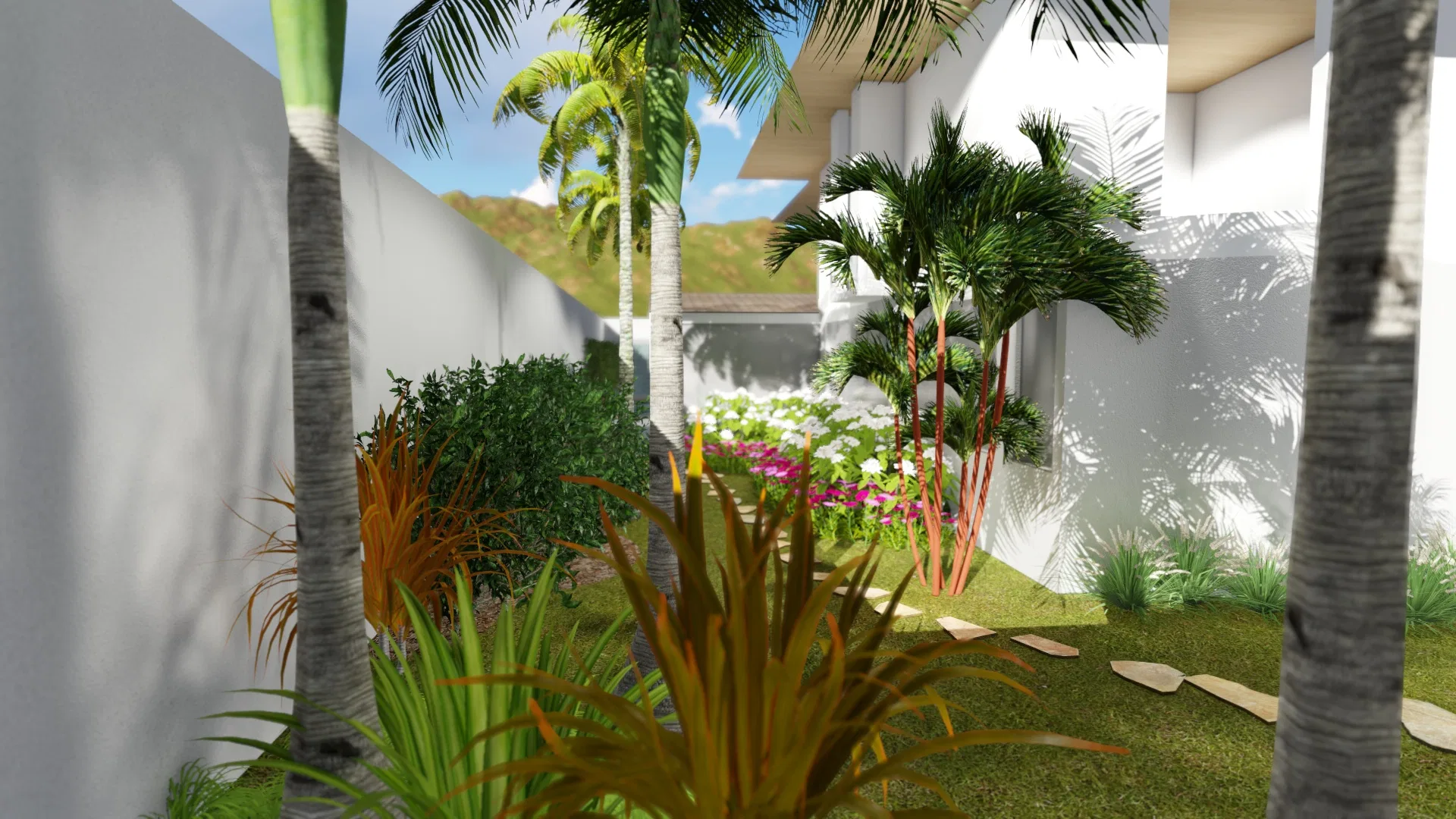Nook among palms with orange-toned foliage, a bed of pink and white flowers and a stone path, mountains beyond the wall