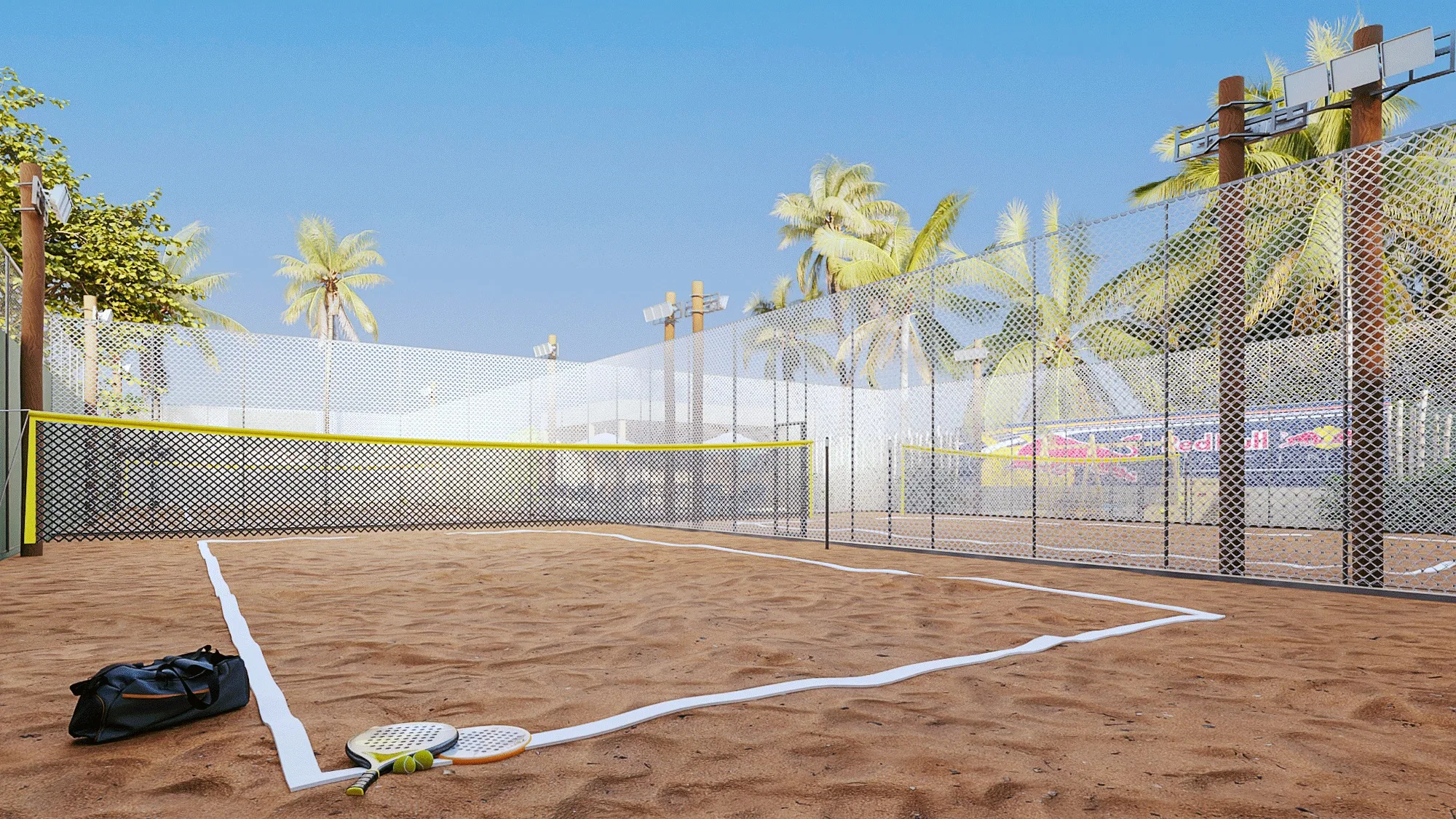 Low over the sand, the beach tennis court shows a yellow tape net, mesh fencing, coconut palms behind and a bag with rackets in the foreground