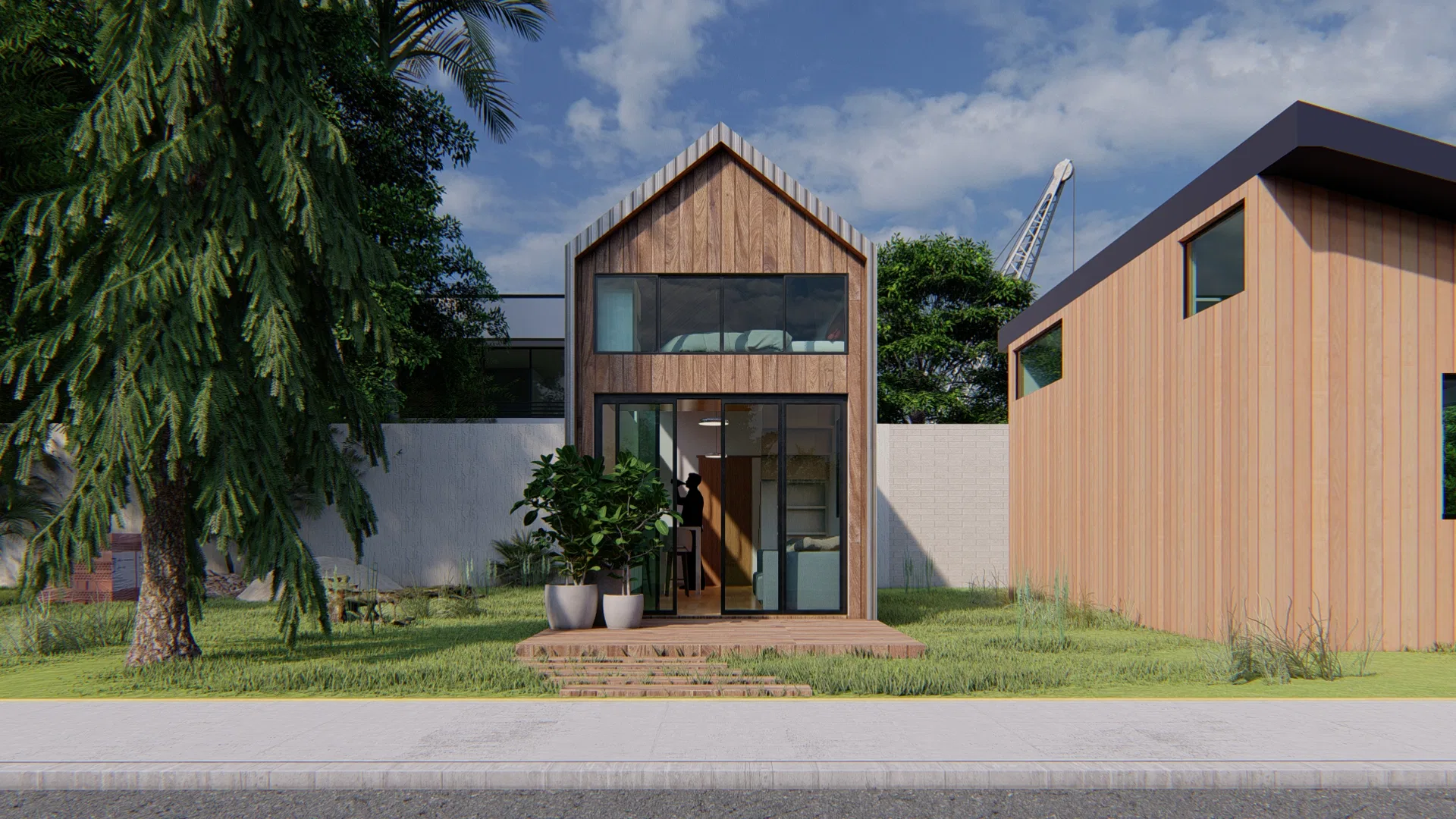 Narrow timber-slat facade with a gable roof, a glazed entrance door and planters, a construction crane visible in the background