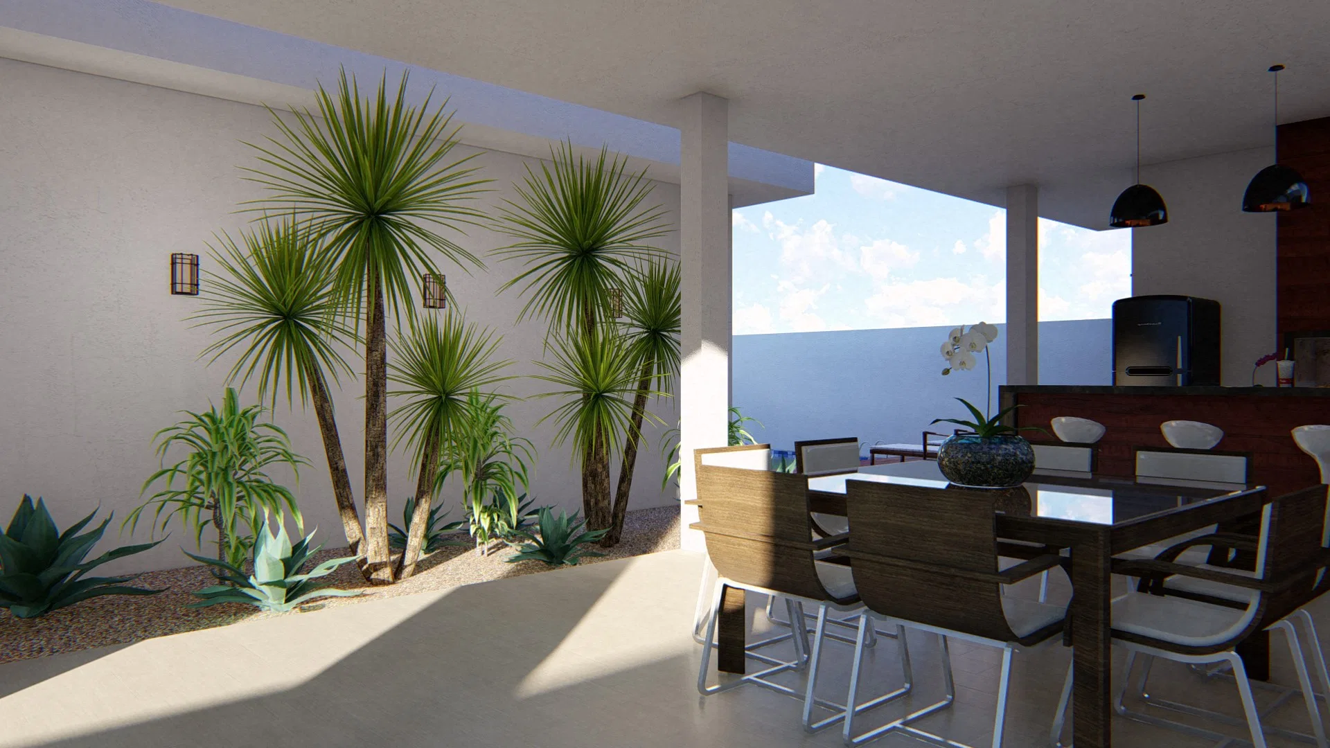 Covered gourmet area with a wooden dining table, dark pendants and a built-in grill, beside a gravel bed with dracaenas and agaves