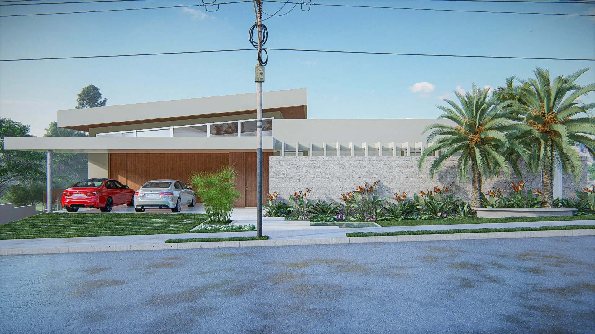 House facade with a red car and a white car under a carport, a white brick wall and a flowering bed along the driveway, with palm trees in the background