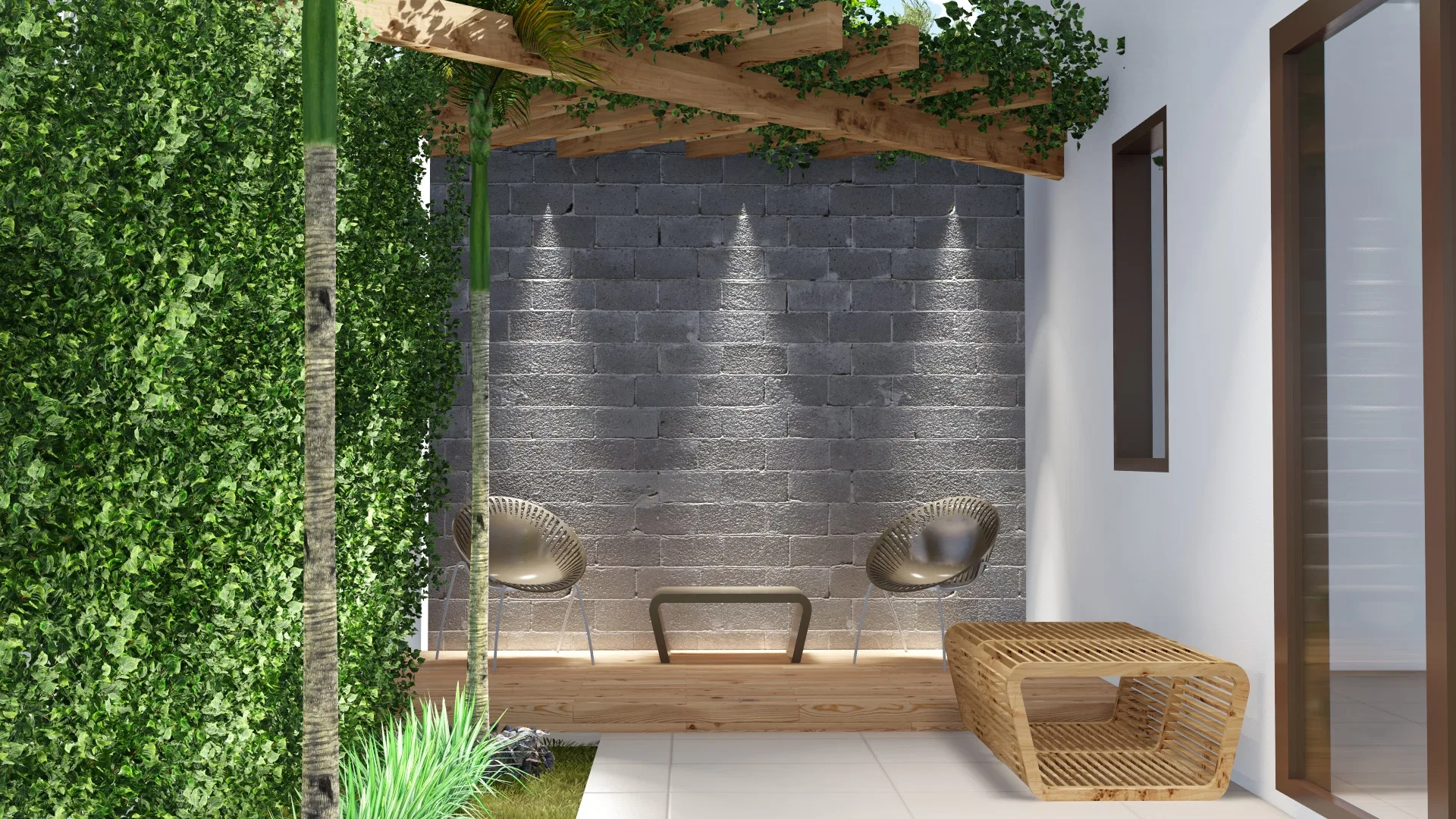 Outdoor lounge under a pergola with an exposed-block wall lit by recessed spots, two woven armchairs and a rattan table beside a dense hedge.