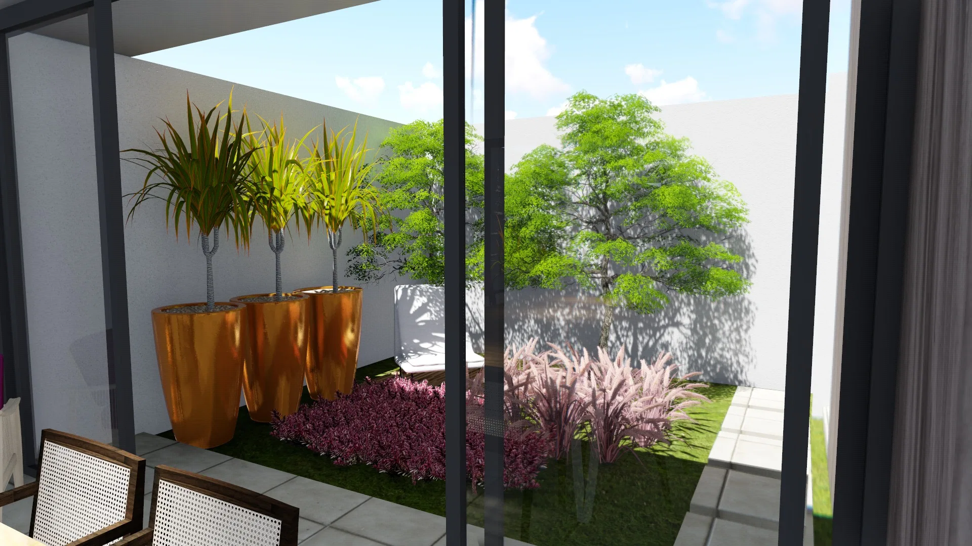 View from indoors to the patio, with copper planters and dracaenas, a leafy tree and a bed of rosy foliage beyond