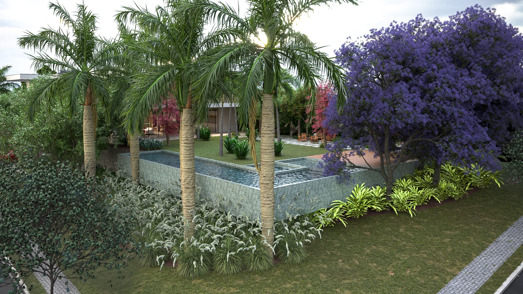 Elevated view of a long reflecting pool edged by royal palms with dense underplanting, a flowering jacaranda and lawn beyond