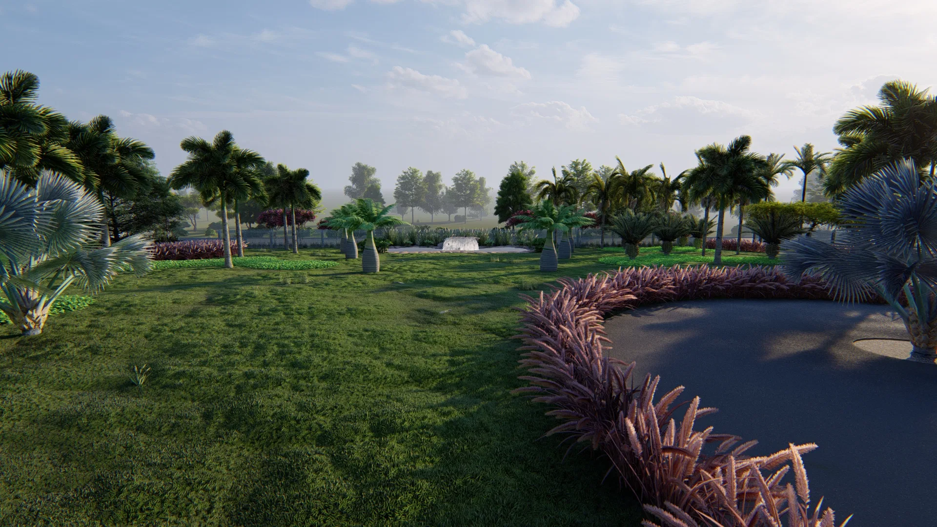 Open garden with varied palms and expansive lawn, mist from a distant fountain and a curved bed of reddish grasses framing a dark paved area.