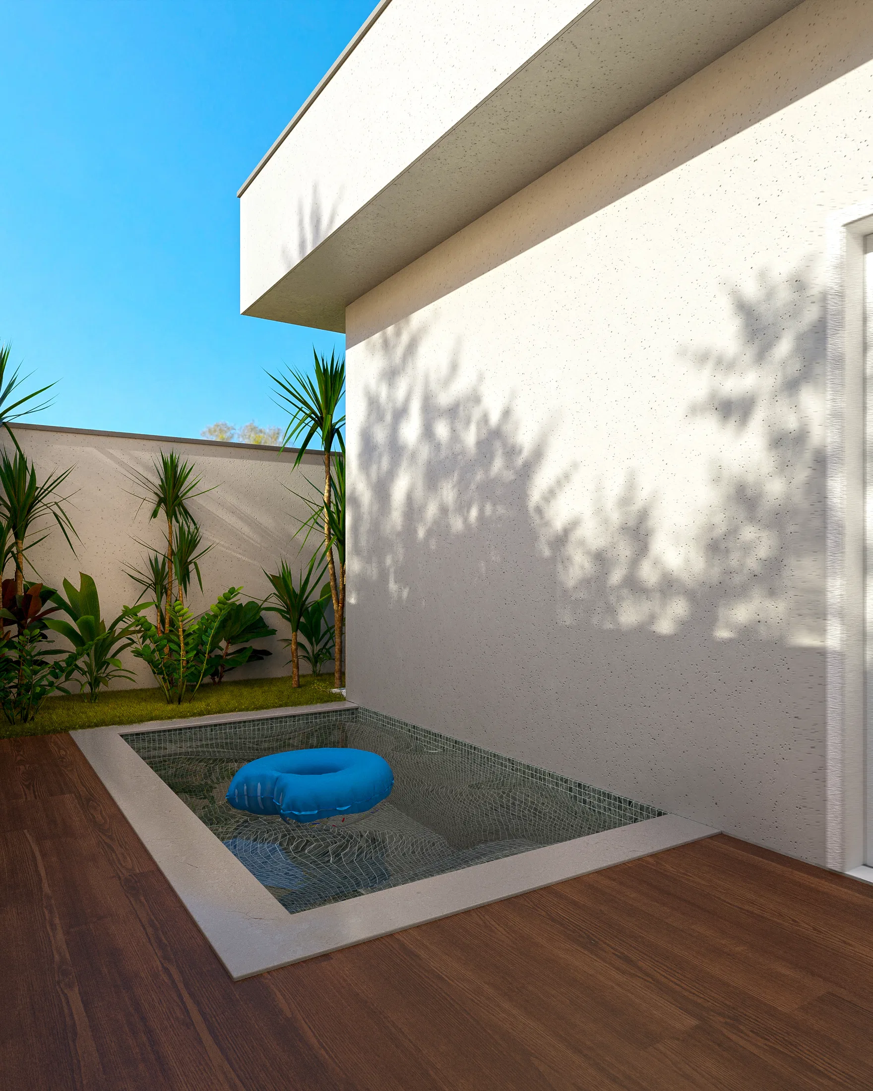 Masonry pool lined with mosaic tile next to the wall, a blue inflatable float and a wood deck around it
