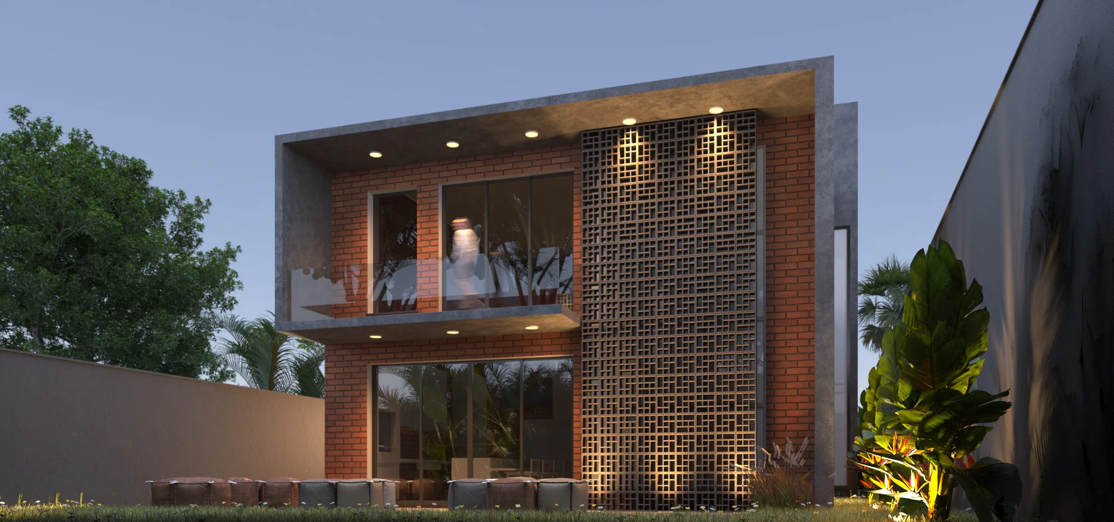 The same brick facade at dusk, with the perforated panel lit and interior light visible through the glass doors