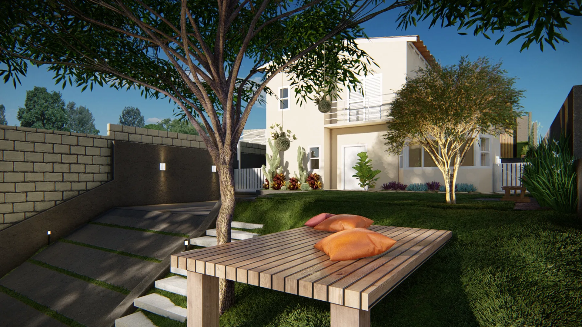 Low timber daybed with orange cushions under a tree, a stepping-stone path down the bank and the two-storey house with a cactus bed beyond